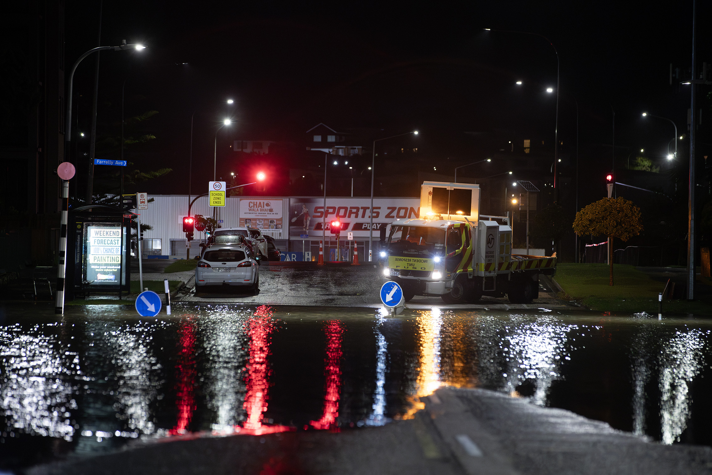 Traffic management closed a section of Sandringham Road, on April 19 as floodwaters entered properties and flooded the street. Photo / Hayden Woodward