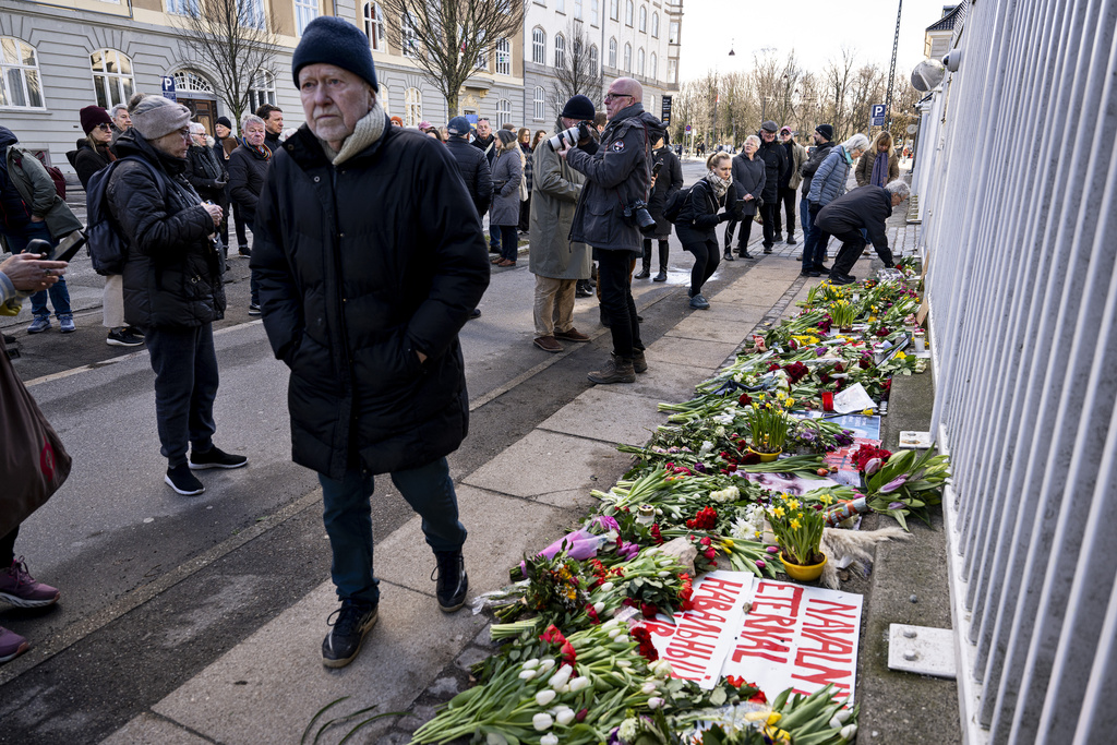 People lay flowers in front of the Russian embassy in Copenhagen, Denmark on February 17. Photo / Nils Meilvang, Ritzau Scanpix via AP
