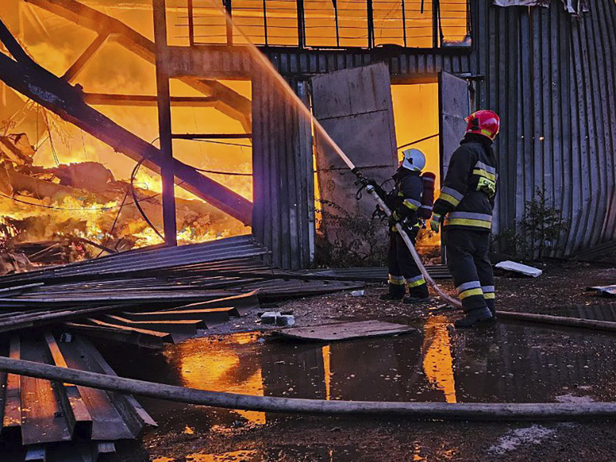 Emergency crews work to extinguish a warehouse fire after a Russian drone attack in Lviv, Ukraine. Photo / AP