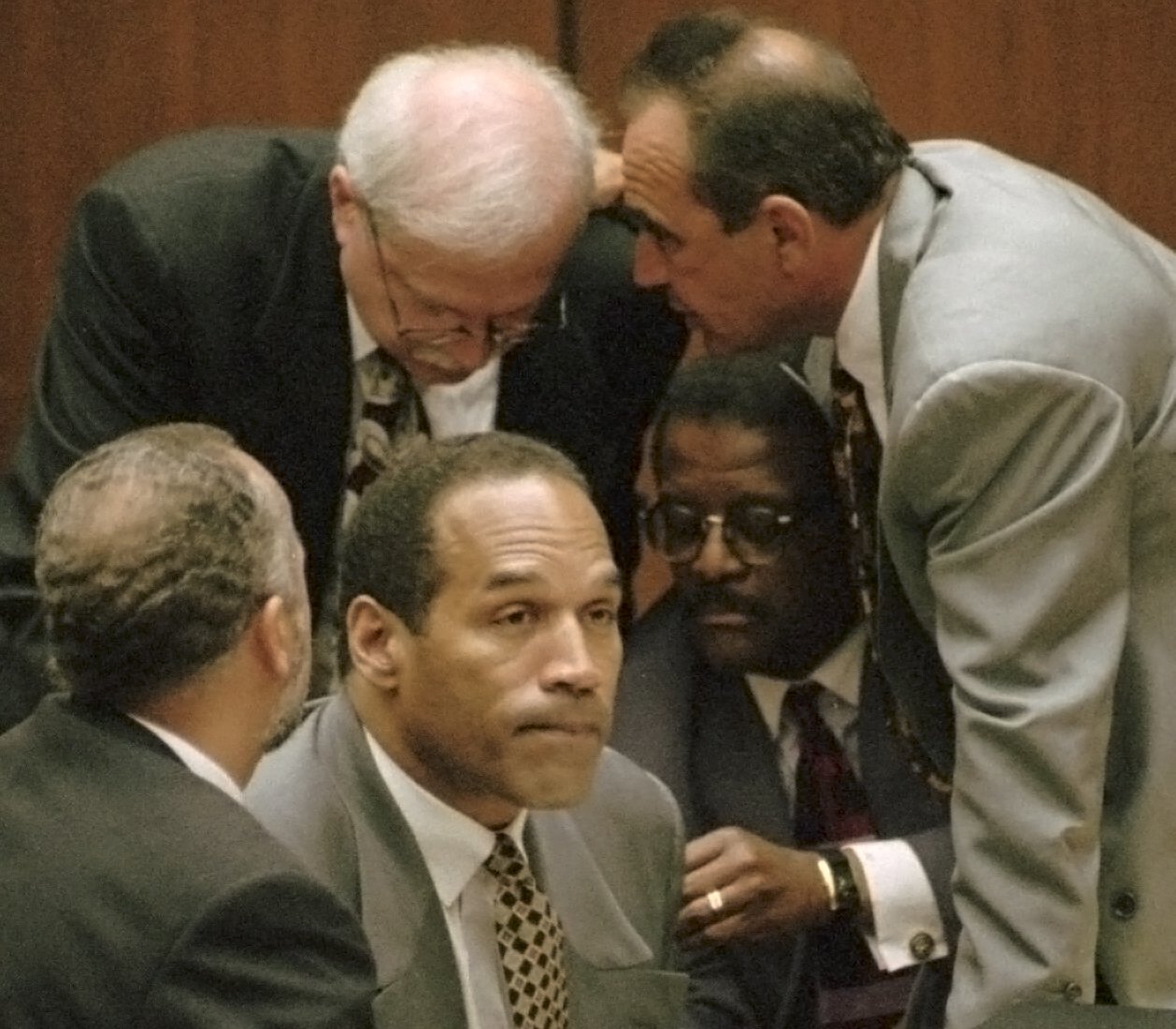 O.J. Simpson is surrounded by his defence attorneys during his murder trial in 1995. Photo / Los Angeles Daily News via AP