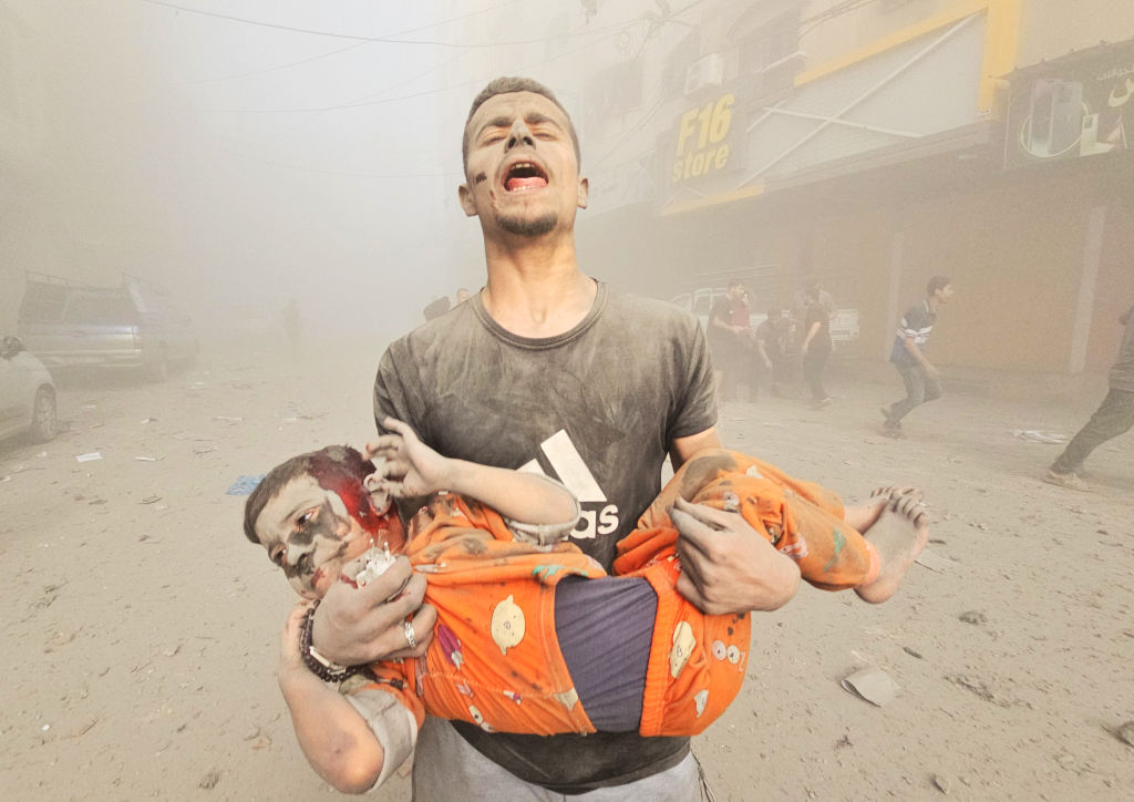 A man carries an injured Palestinian child as Israeli attacks continue on the 25th day at Jabalia refugee camp in Gaza City on October 31. Photo / Getty