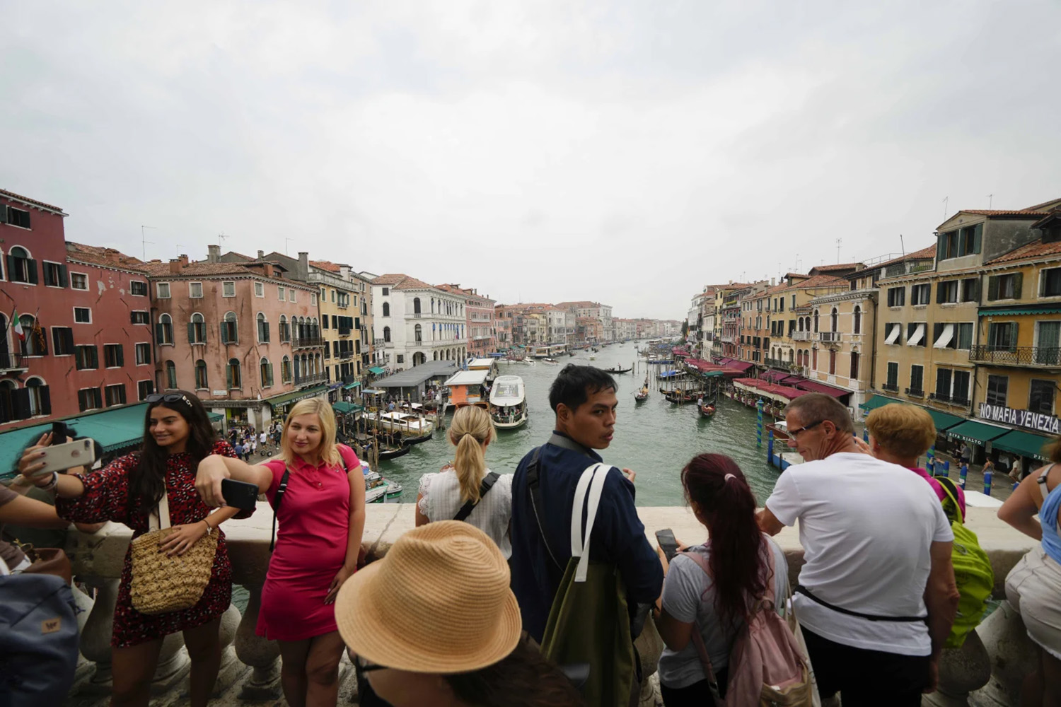 Tourists pose for pictures in Venice. Photo / AP