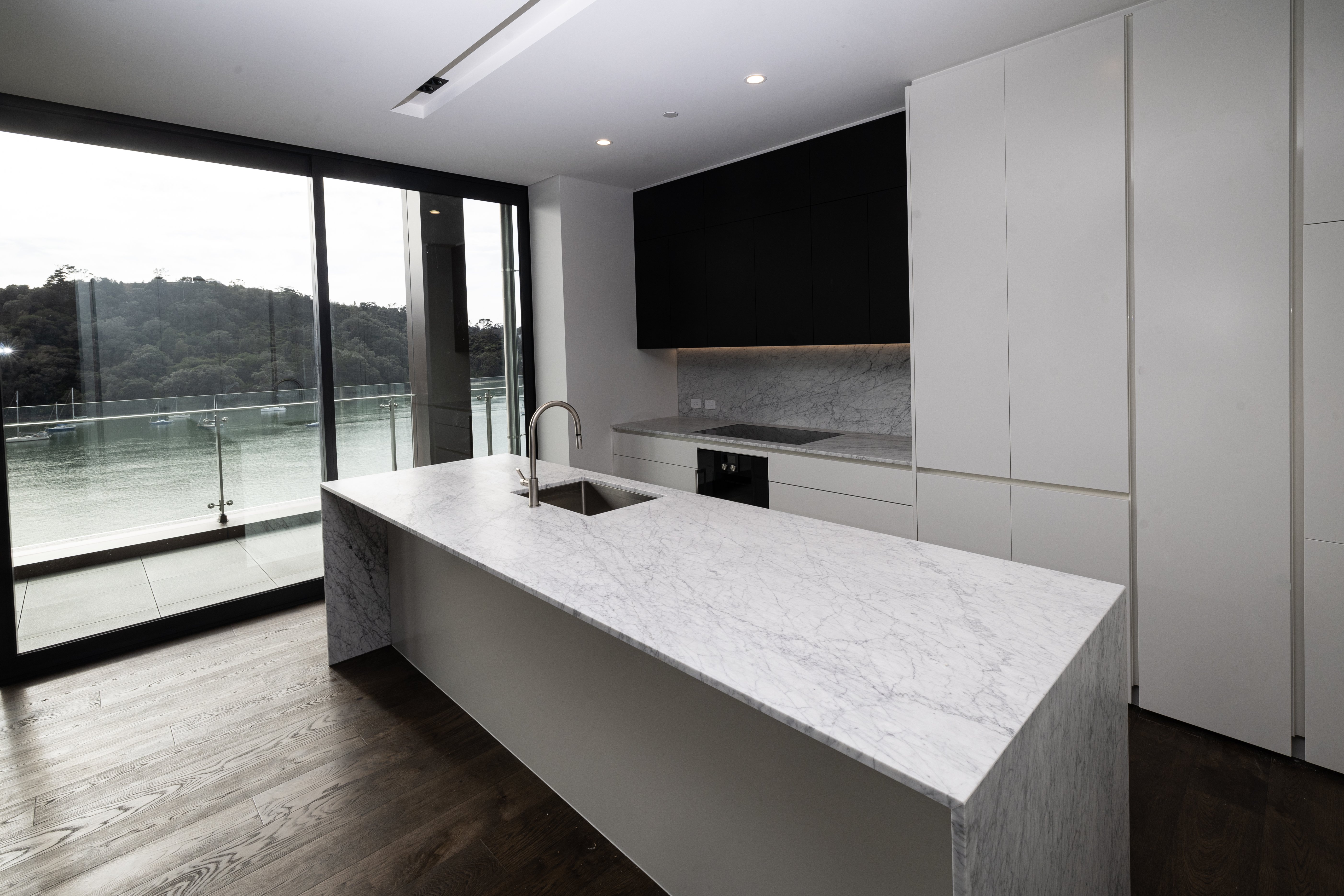 Kitchen with waterfall marble benches at Catalina Bay Apartments. Photo / Jason Oxenham