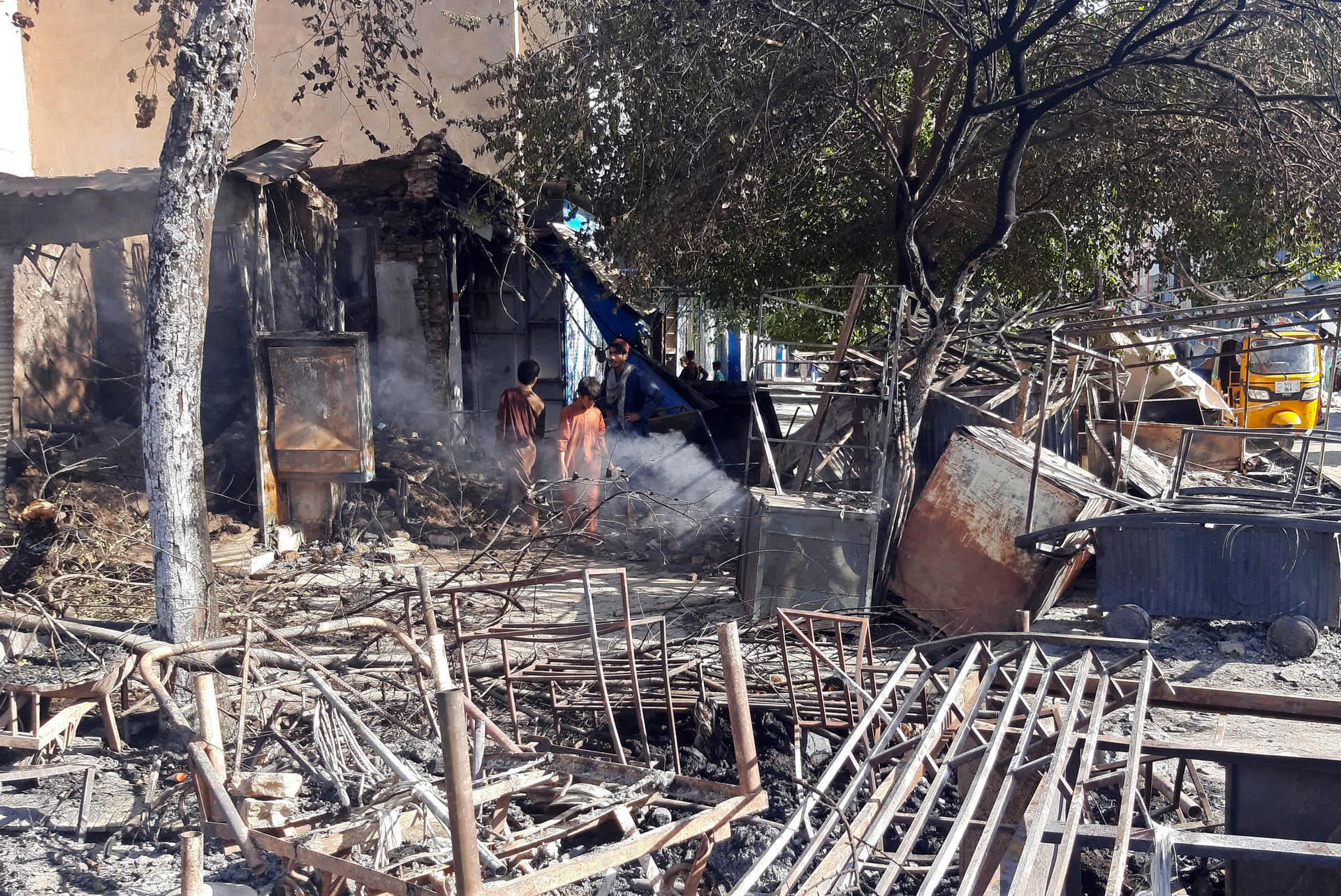 Afghans inspect damaged shops after fighting between Taliban and Afghan security forces in Kunduz city, northern Afghanistan. Photo / AP