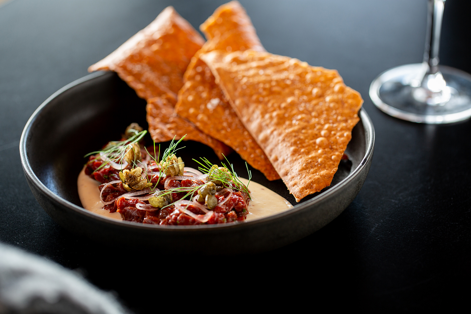 The venison tartare with charcoal mayonnaise and lavosh. Photo / Babiche Martens