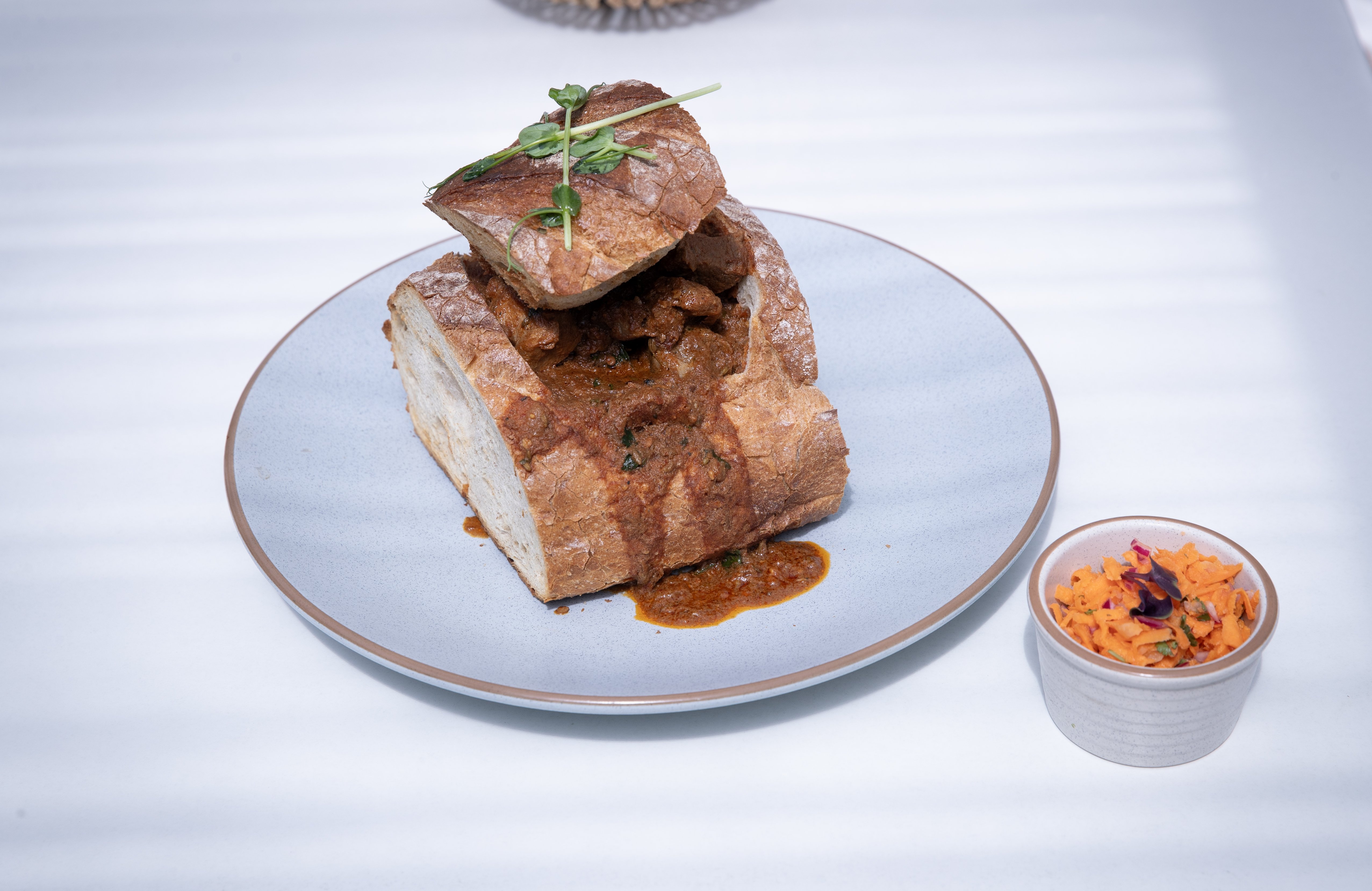 Okumnandi's bunny chow with carrot salad. Photo / Dean Purcell
