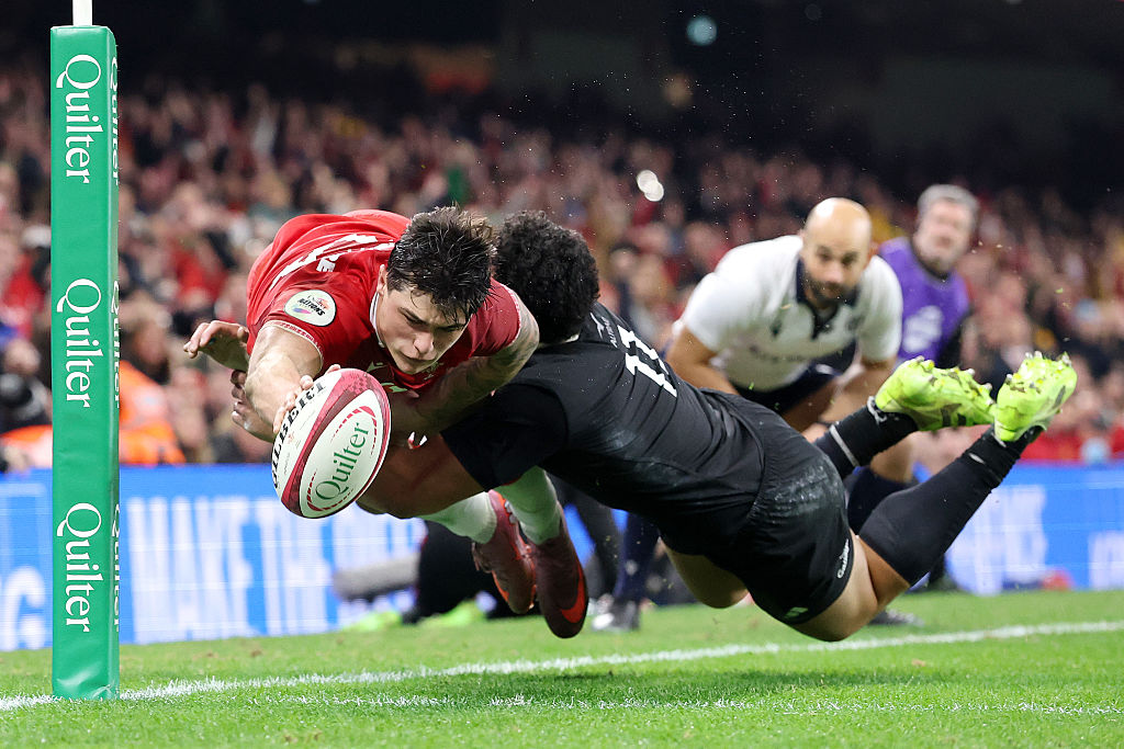 Louis Rees-Zammit of Wales scores his team's fourth try while being tackled by Caleb Clarke. Photo / Getty Images
