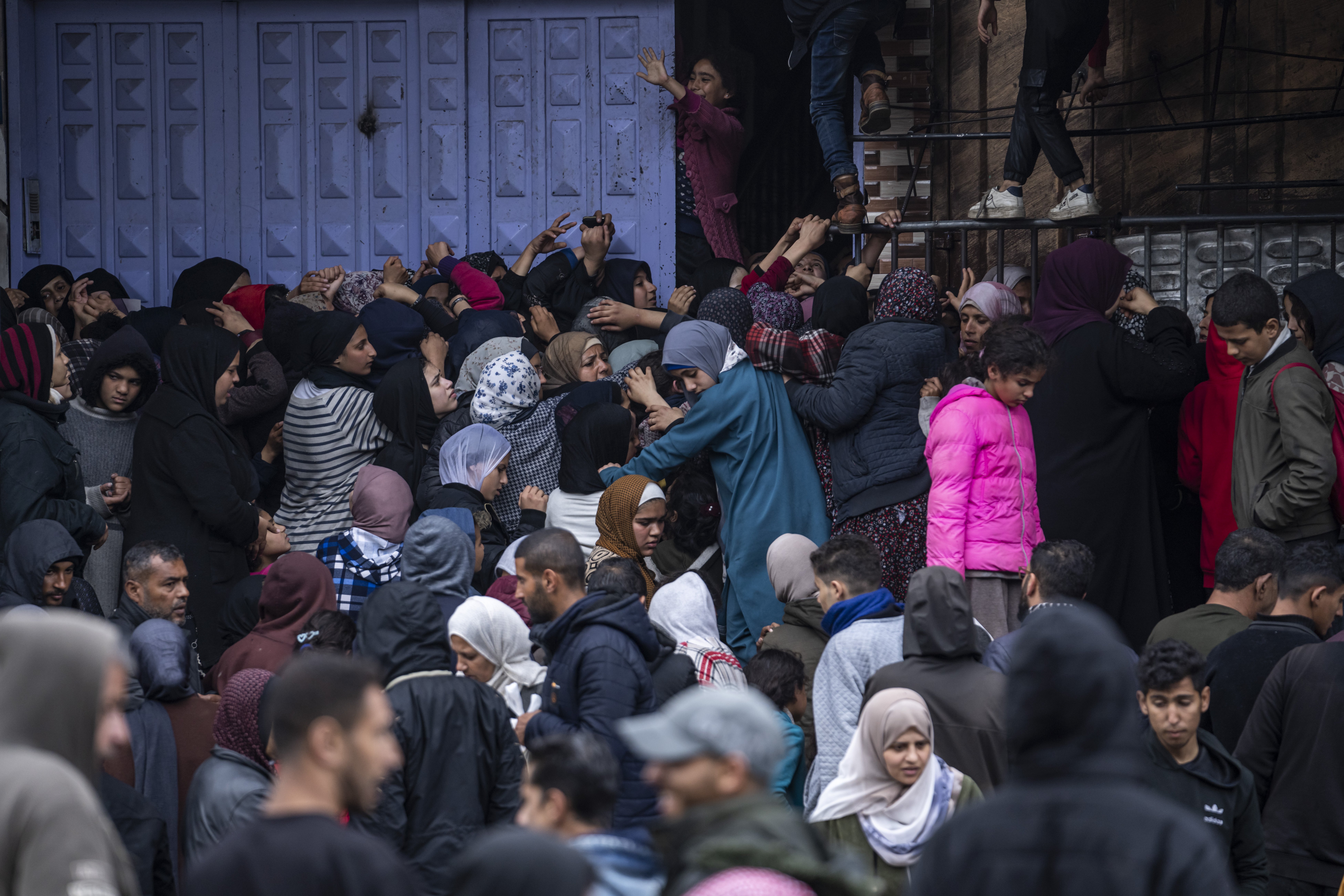 Palestinian crowds struggle to buy bread from a bakery in Rafah, Gaza Strip. Photo / AP
