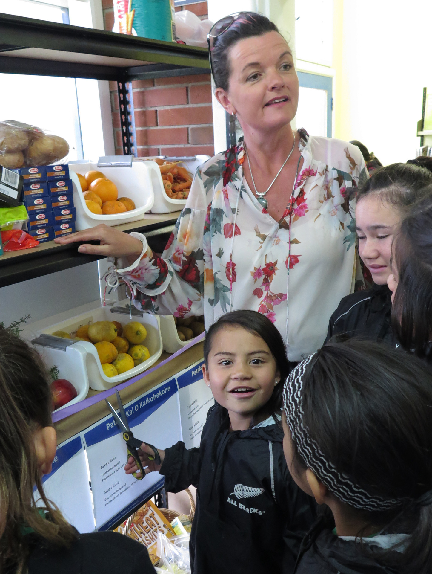Nine-year-old Shelby Hori-Broomfield, seen here with Deputy Mayor Tania McInnes, cuts the ribbon for the new pataka kai at Kaikohe Library. Photo / Peter de Graaf 