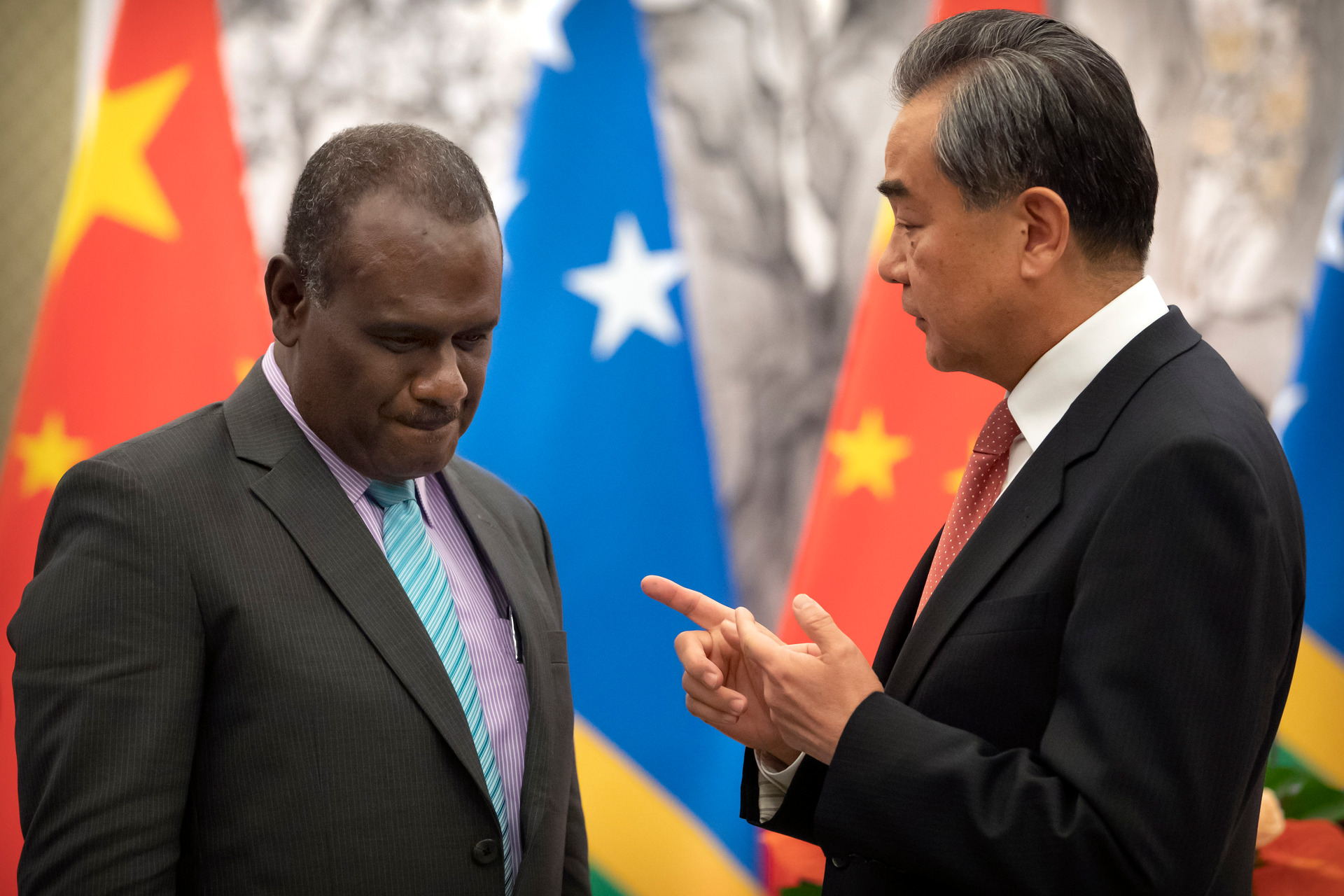 Solomon Islands Foreign Minister Jeremiah Manele, left, and Chinese Foreign Minister Wang Yi talk during a ceremony to mark the establishment of diplomatic relations. Photo / AP