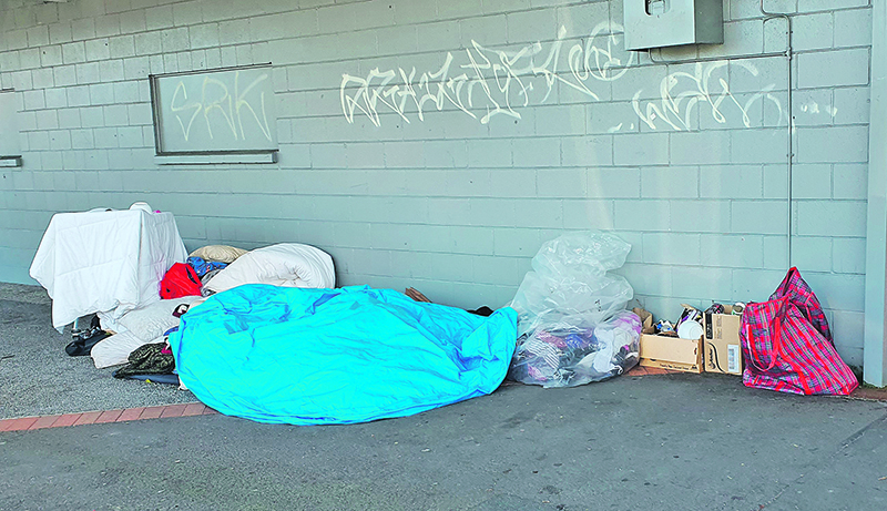 Bedding and belongings piled on the pavement on Goulstone Rd caused loss of custom for several nearby businesses. Photo / Diane McCarthy