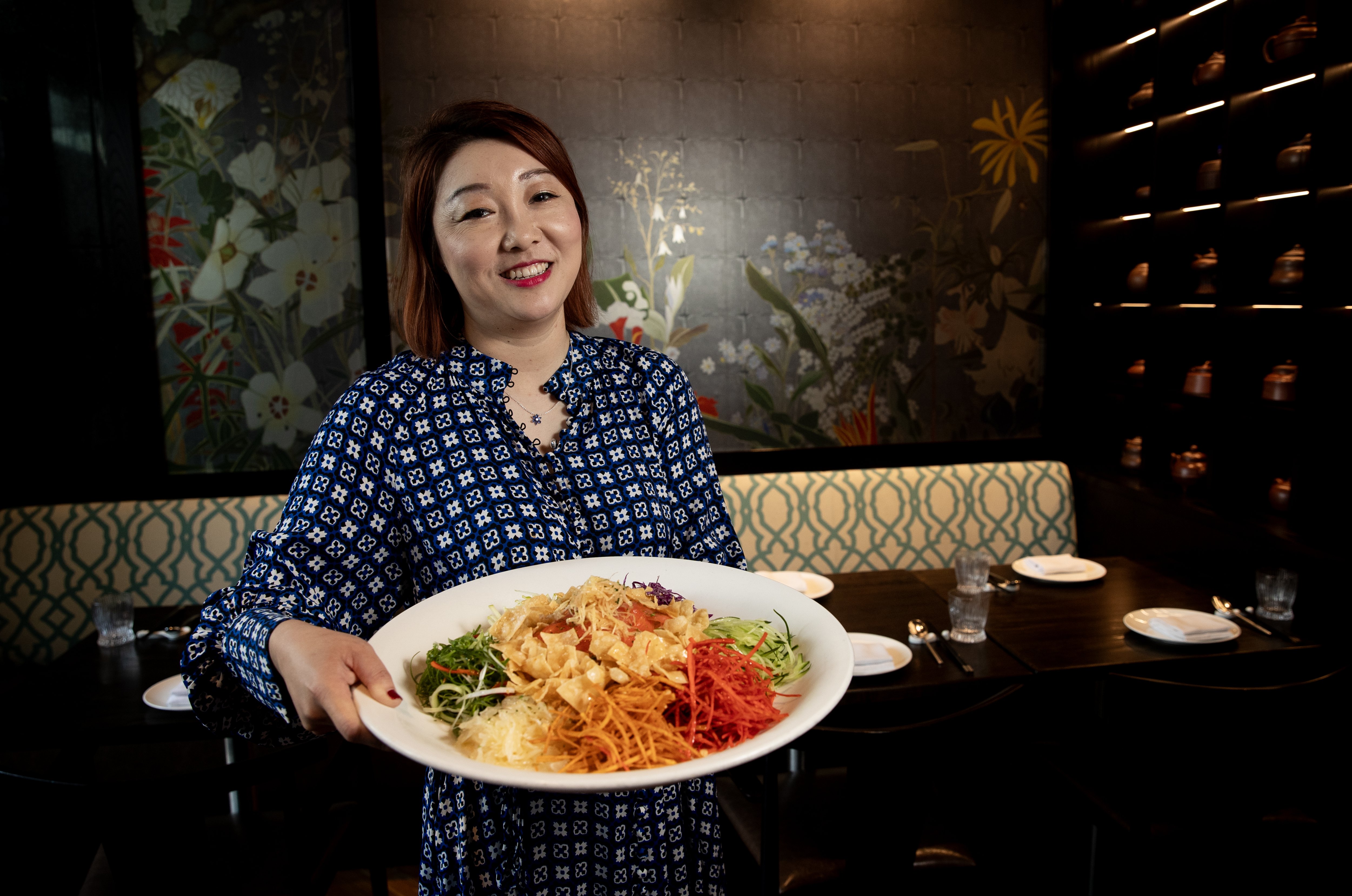Daisy Ding, manager of Huami Restaurant SkyCity, with a platter of yusheng prosperity salad. Photo / Dean Purcell