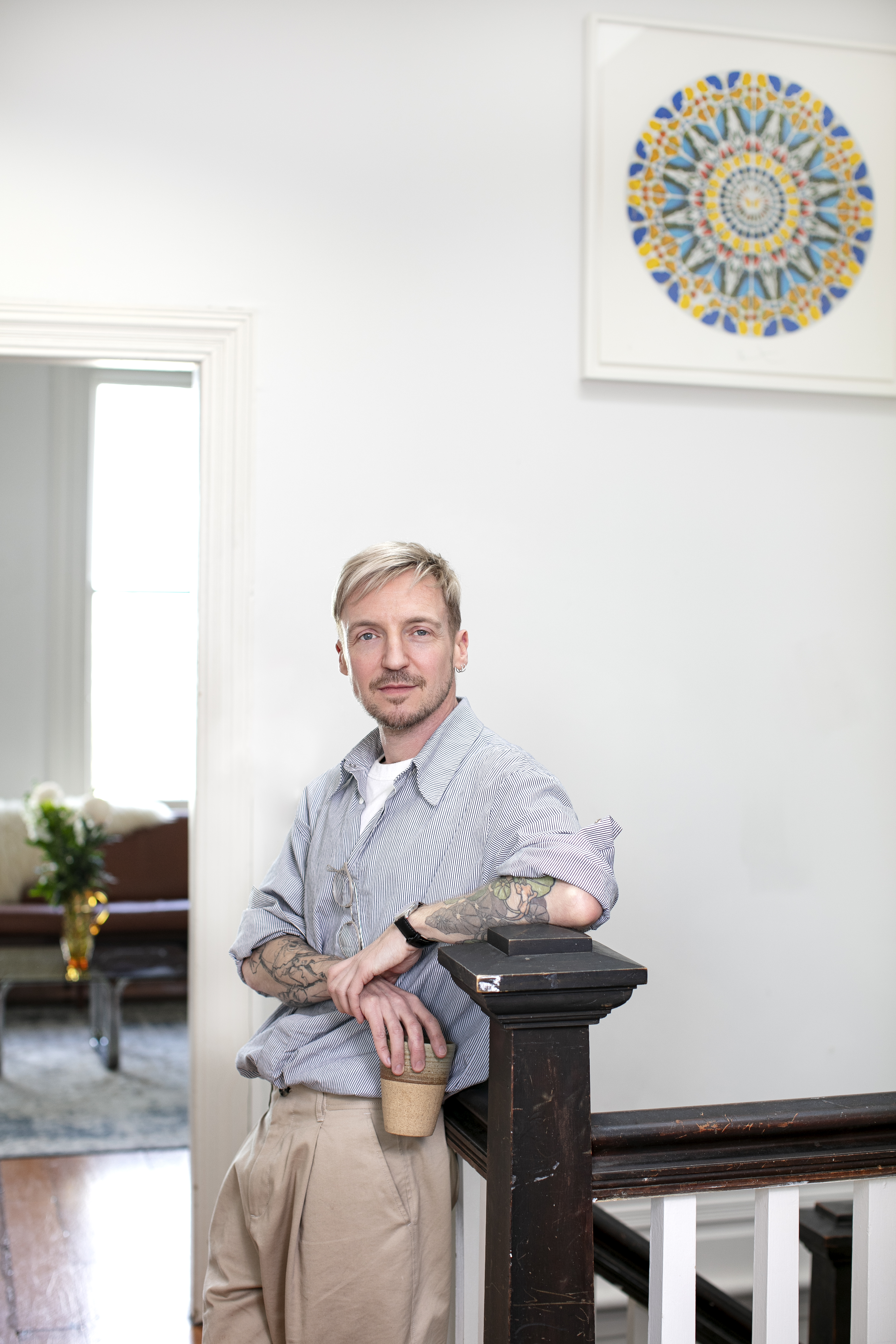 Rory Docherty at home in Kingsland. The artwork is by Damien Hirst. Photo / Babiche Martens