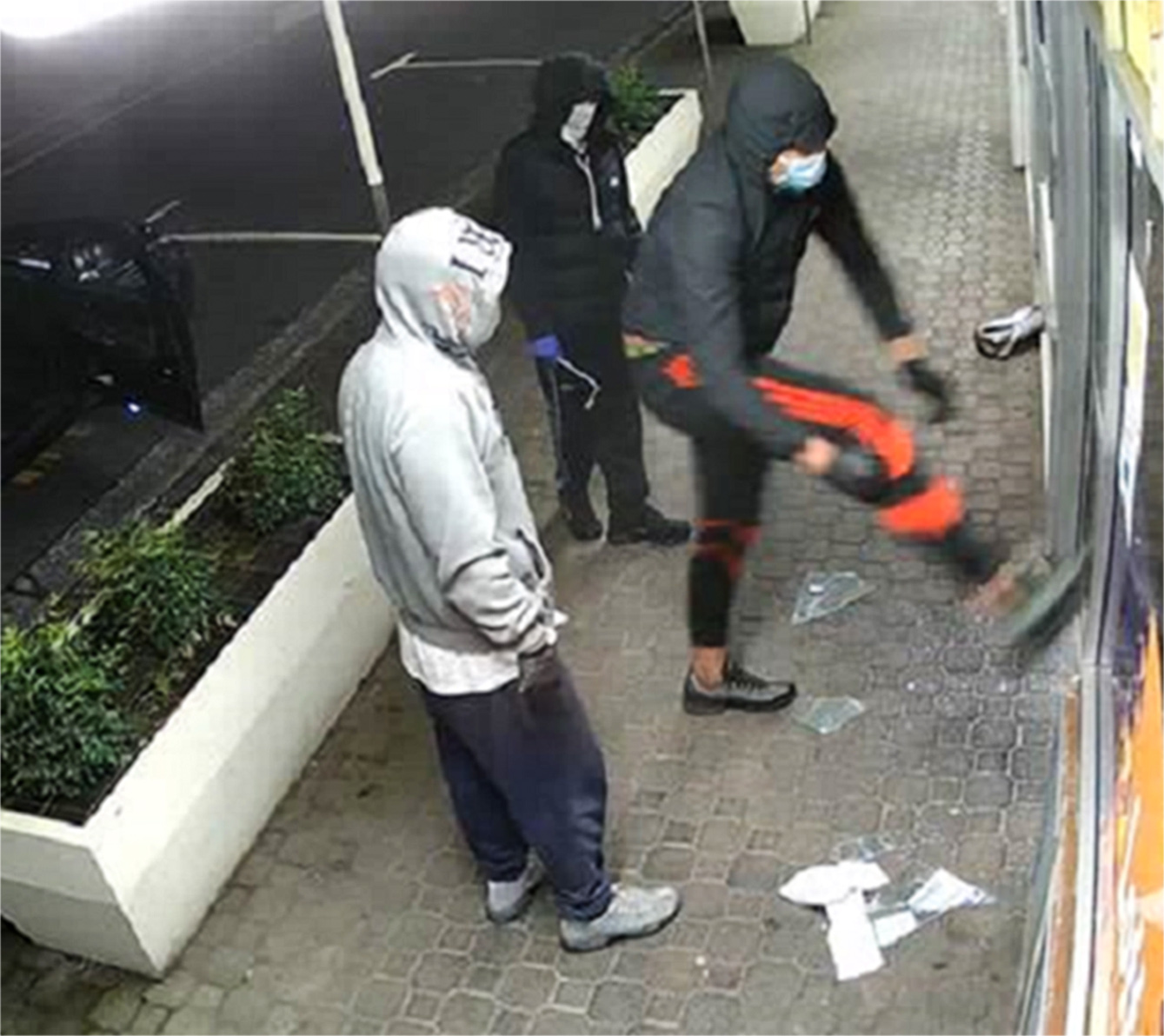 A security camera image captures teenagers trying to break into a store in Hamilton. Photo / NZ Police