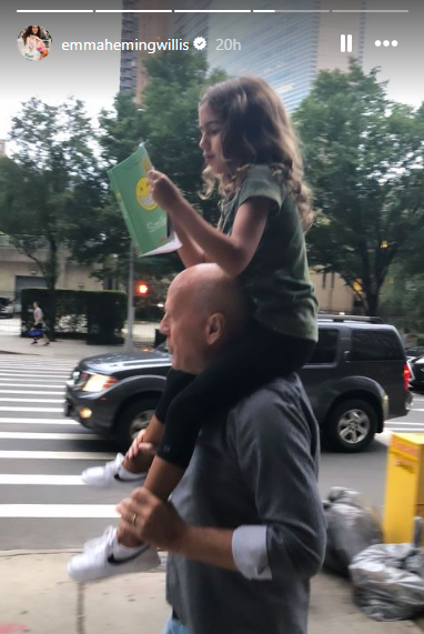 In a photo shared to Emma Heming Willis' Instagram, Bruce Willis can be seen walking along the street while carrying his daughter Mabel on his shoulders.