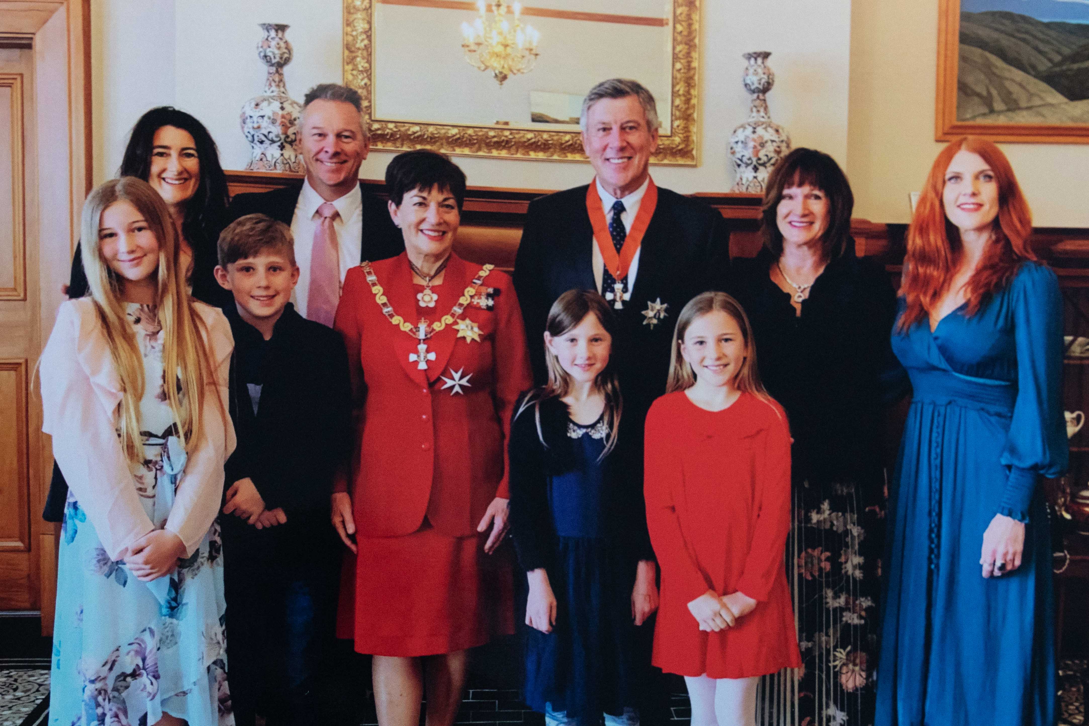 Sir Paul Adams at his knighthood ceremony in 2019. From back left Nicky and Scott Adams, Governor General Patsy Reddy, Lady Cheryl Adams, Sarah Adams and grandchildren Isabella, Hunter, Frankie and Tallulah. Photo / Supplied