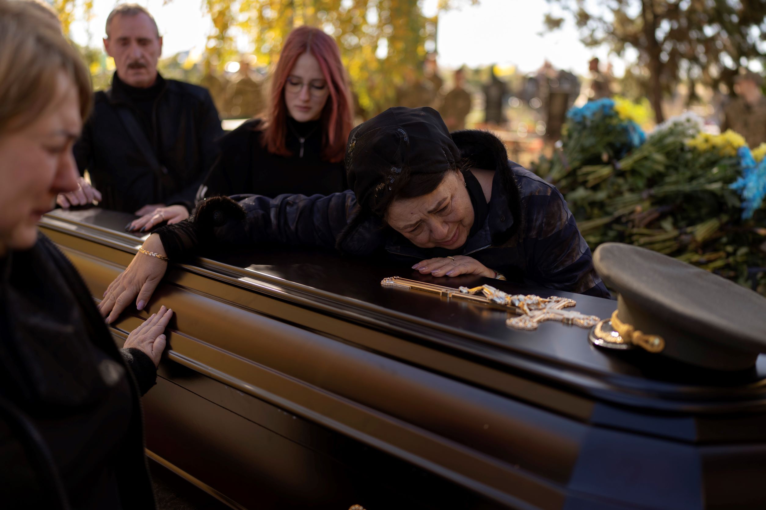 Tatiana Alexeyevna mourns over the coffin of her son Colonel Oleksiy Telizhenko during his funeral in Bucha, near Kyiv, Ukraine in October. In March, Colonel Oleksiy was abducted by Russian soldiers from his home in Bucha, six months later his body was found with signals of torture buried in a forest not far away from his village. Photo / AP