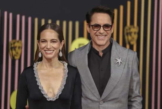 Susan Downey, left, and Robert Downey Jr. pose for photographers upon arrival at the BAFTAs. (Photo by Vianney Le Caer/Invision/AP)
