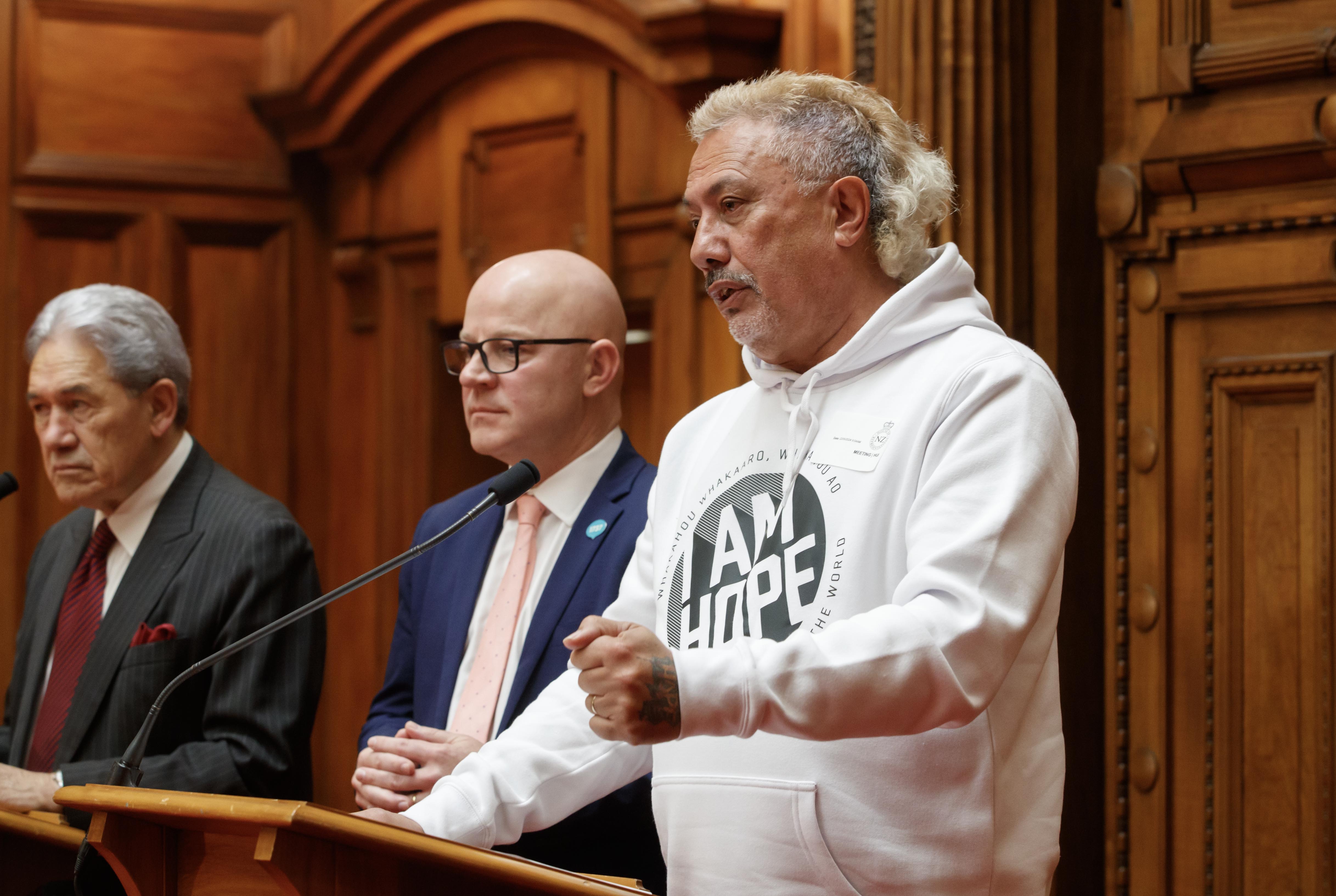 Mental health advocate Mike King with Mental Health Minister Matt Doocey and NZ First leader Winston Peters during a funding announcement in 2024 at Parliament. Photo / Mark Mitchell