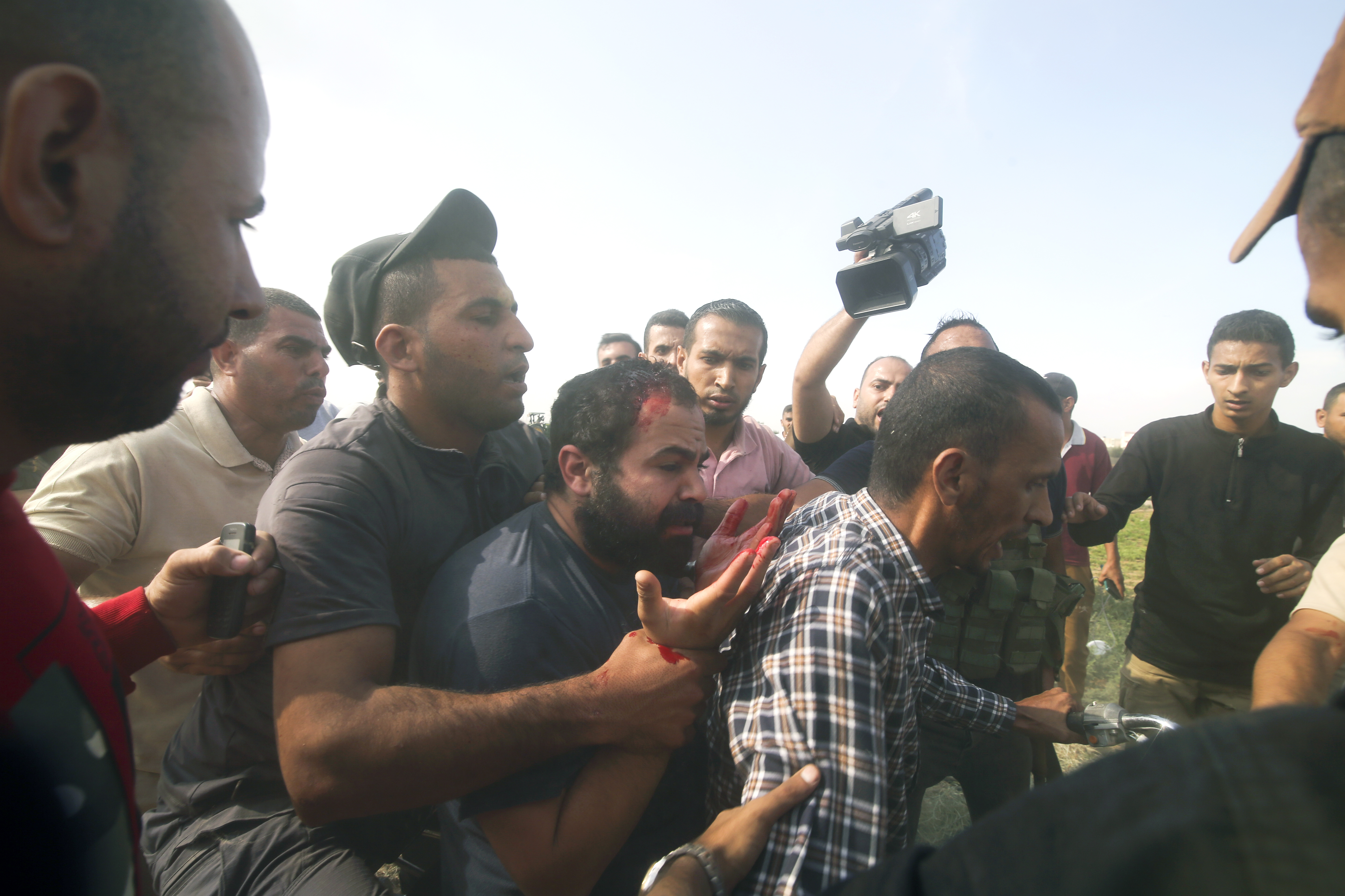 Palestinians transport a captured Israeli civilian, center, from Kibbutz Kfar Azza into the Gaza Strip. Photo / AP