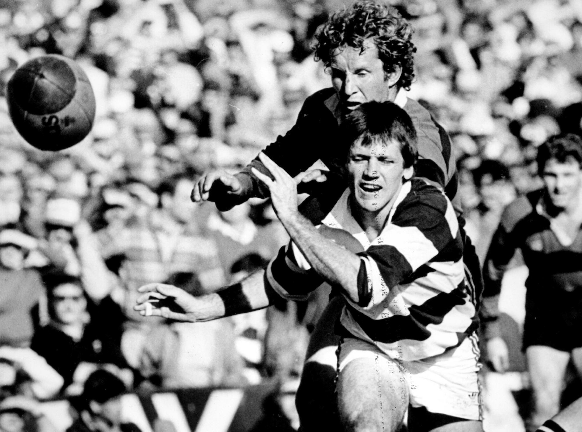 David Kirk passes under the pressure of Bruce Deans during the 1985 Ranfurly Shield match between Auckland and Canterbury. Photo / Photosport