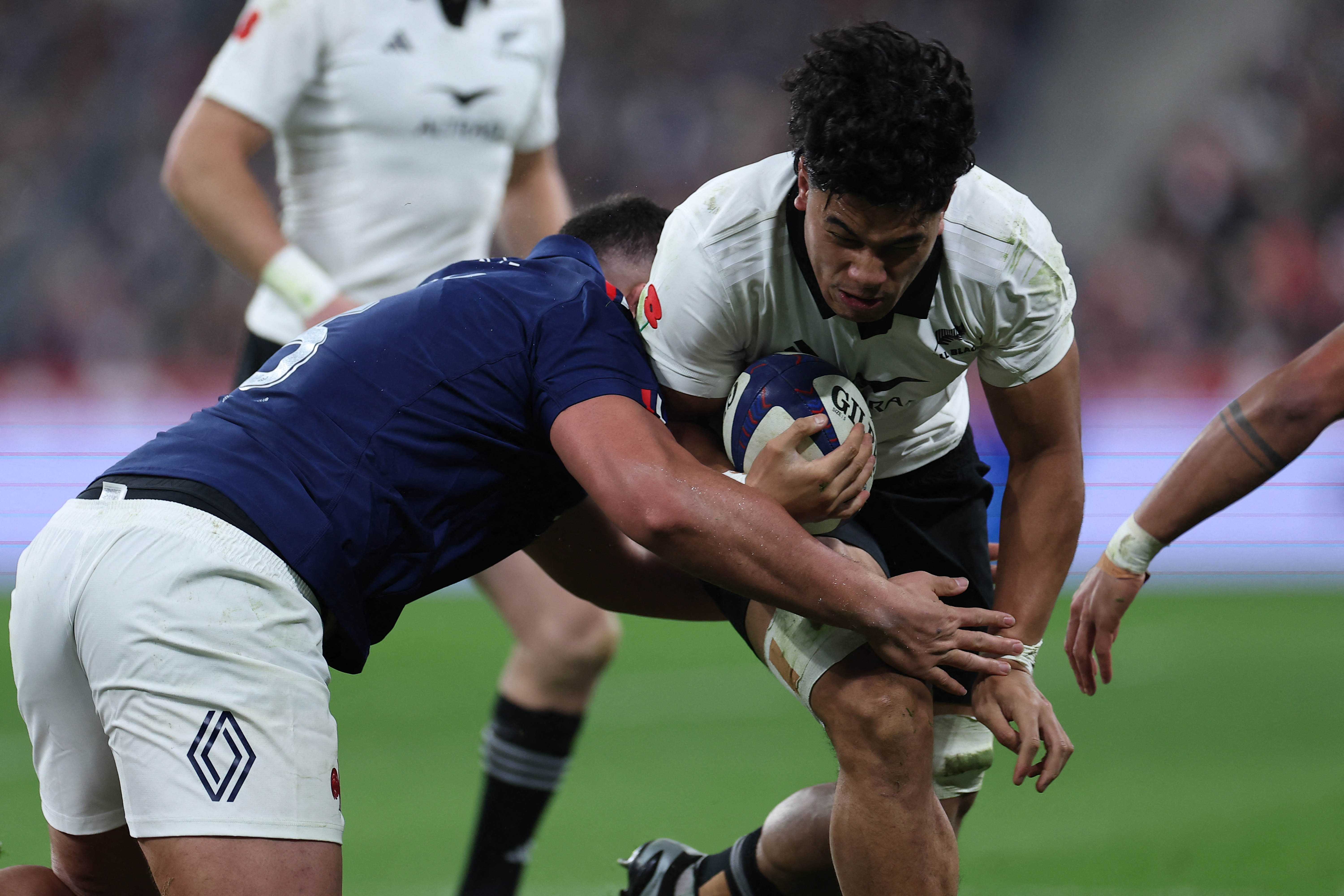 All Black no.8 Wallace Sititi is is tackled by French lock Emmanuel Meafou during the test match at Stade de France. Photo / AFP