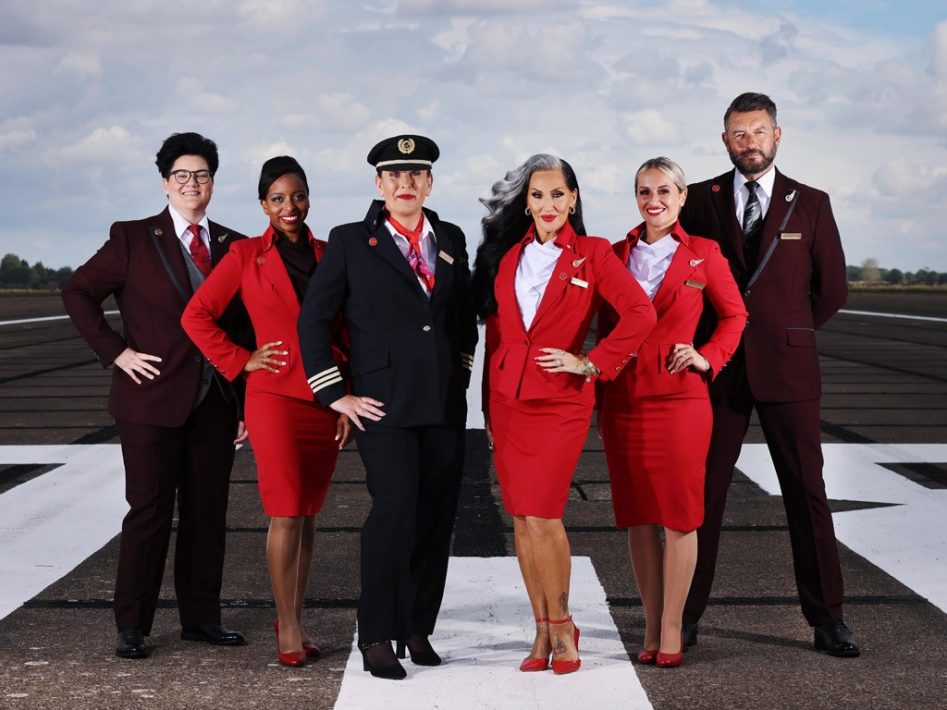 Virgin crew, from left, Jamie Forsstreom, Tania Wiks, Alison Porte, Leigh Dixon, Gary Ogden and celebrity, Michelle Visage, center right, model new-look uniform and pronoun badges. Photo / Supplied