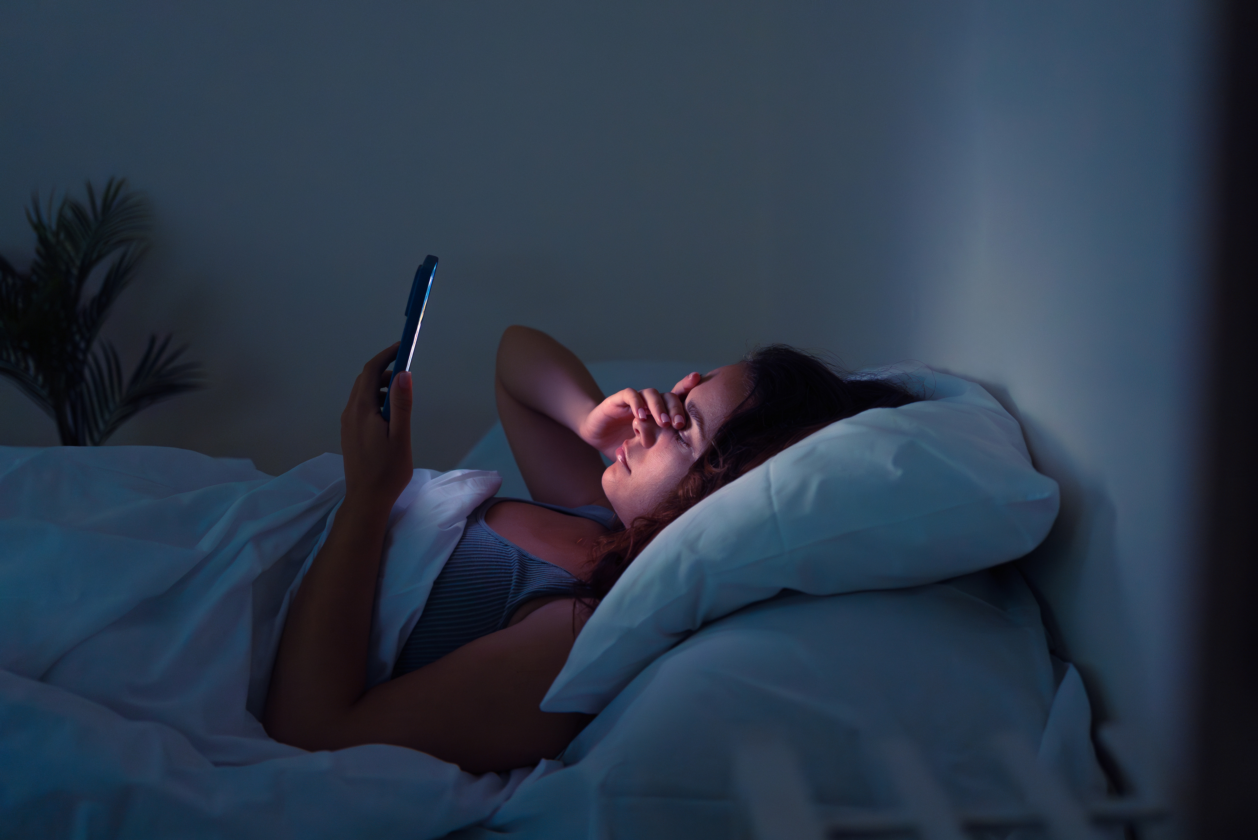 Teens will often be on their phones late at night when they can become online victims of scams. Photo / 123rf