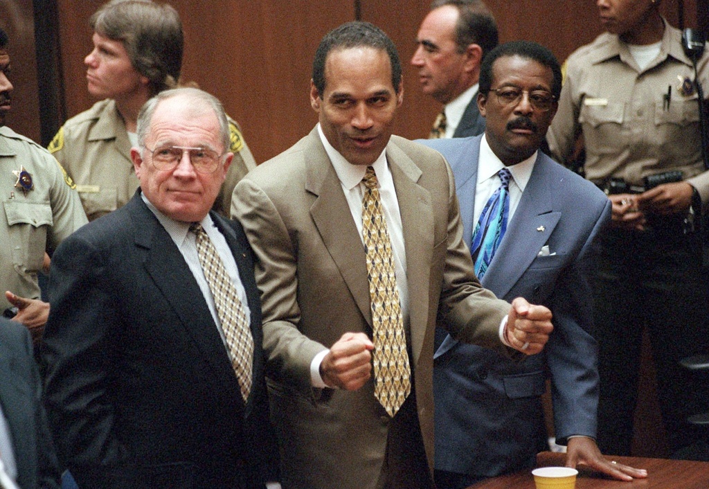 In this October 3, 1995, file photo, O.J. Simpson reacts as he is found not guilty. Defence attorneys F. Lee Bailey (left), and Johnnie L. Cochran Jr. stand with him. Photo / AP