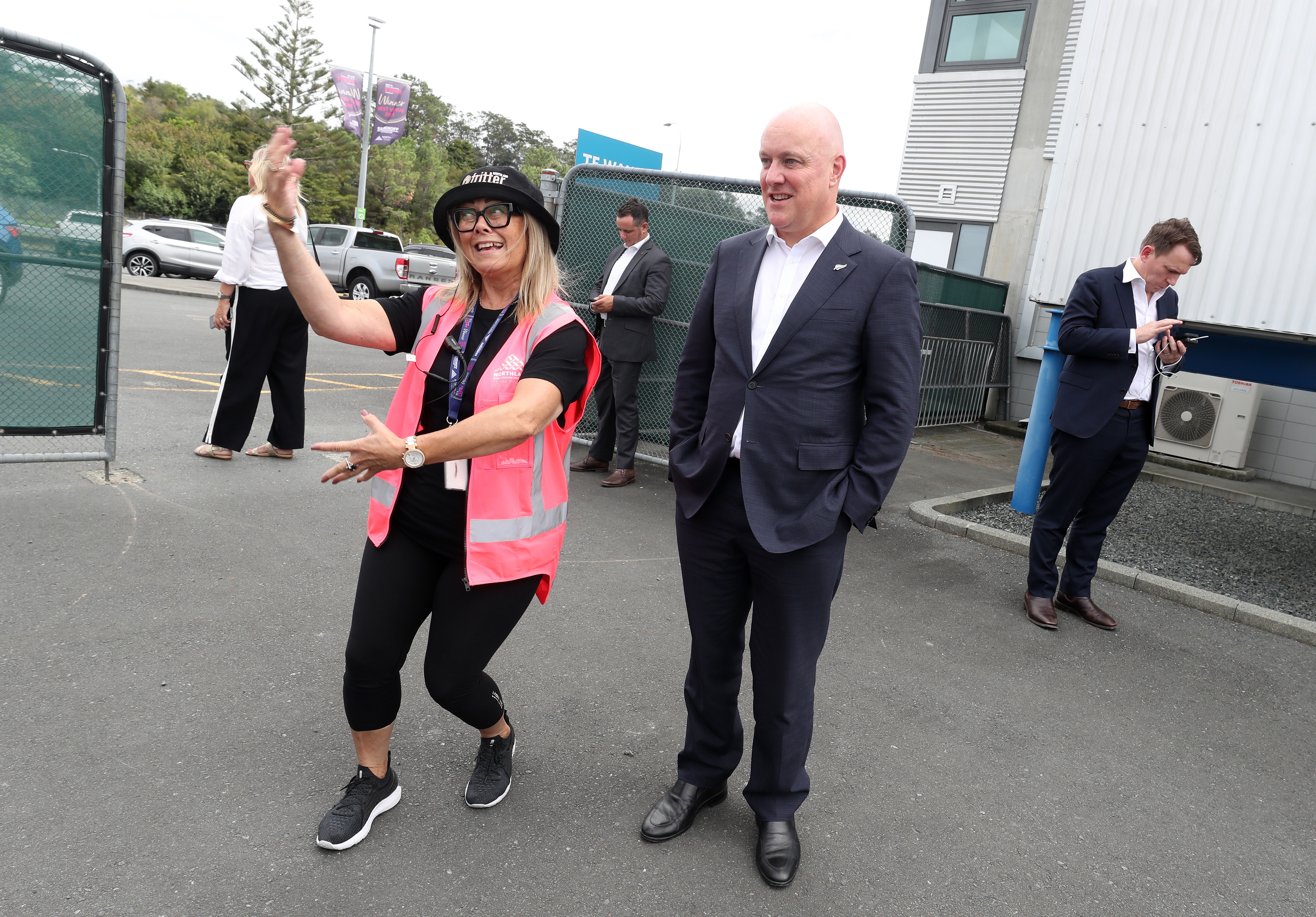 Carina de Graff, general manager of Northland Events Centre Trust at Semenoff Stadium, explains to Prime Minister Christopher Luxon how Saturday's Fritter Festival is set to unfold. Photo / Michael Cunningham
