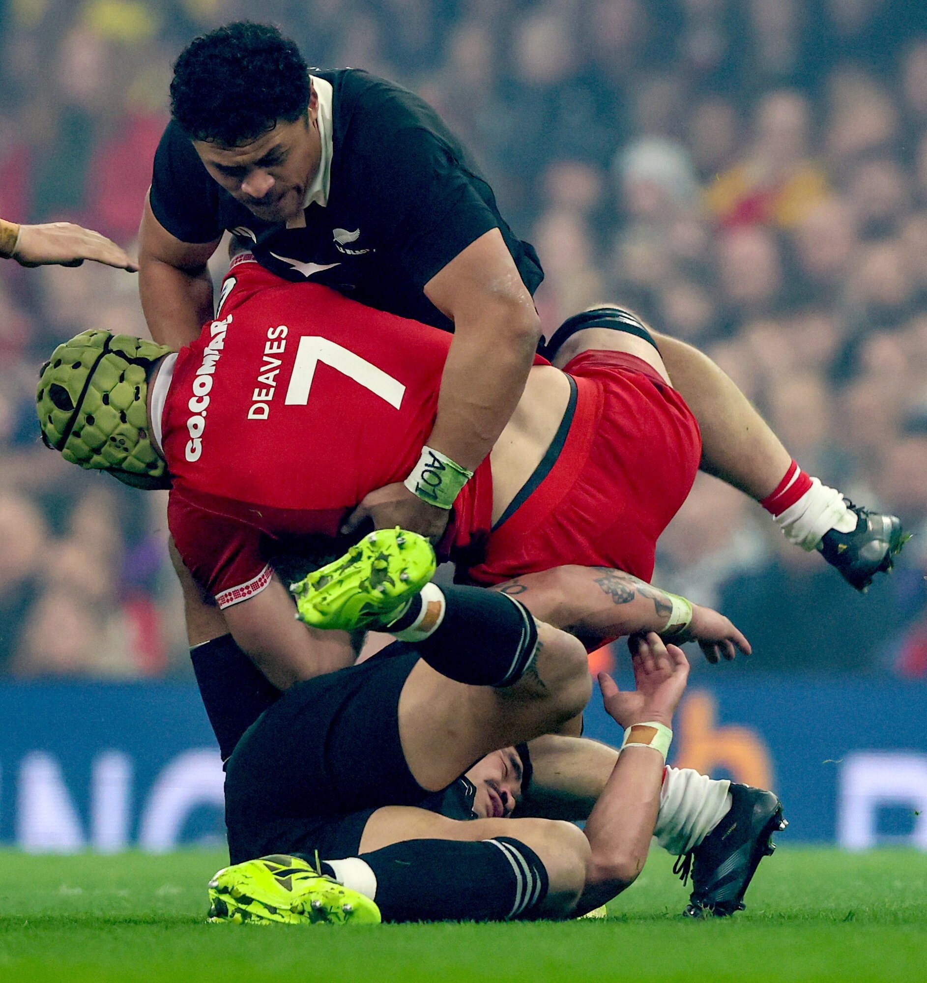 Welsh flanker Harri Deaves is caught in the tackle of Caleb Clarke and Du'Plessis Kirifi. Photo / Photosport