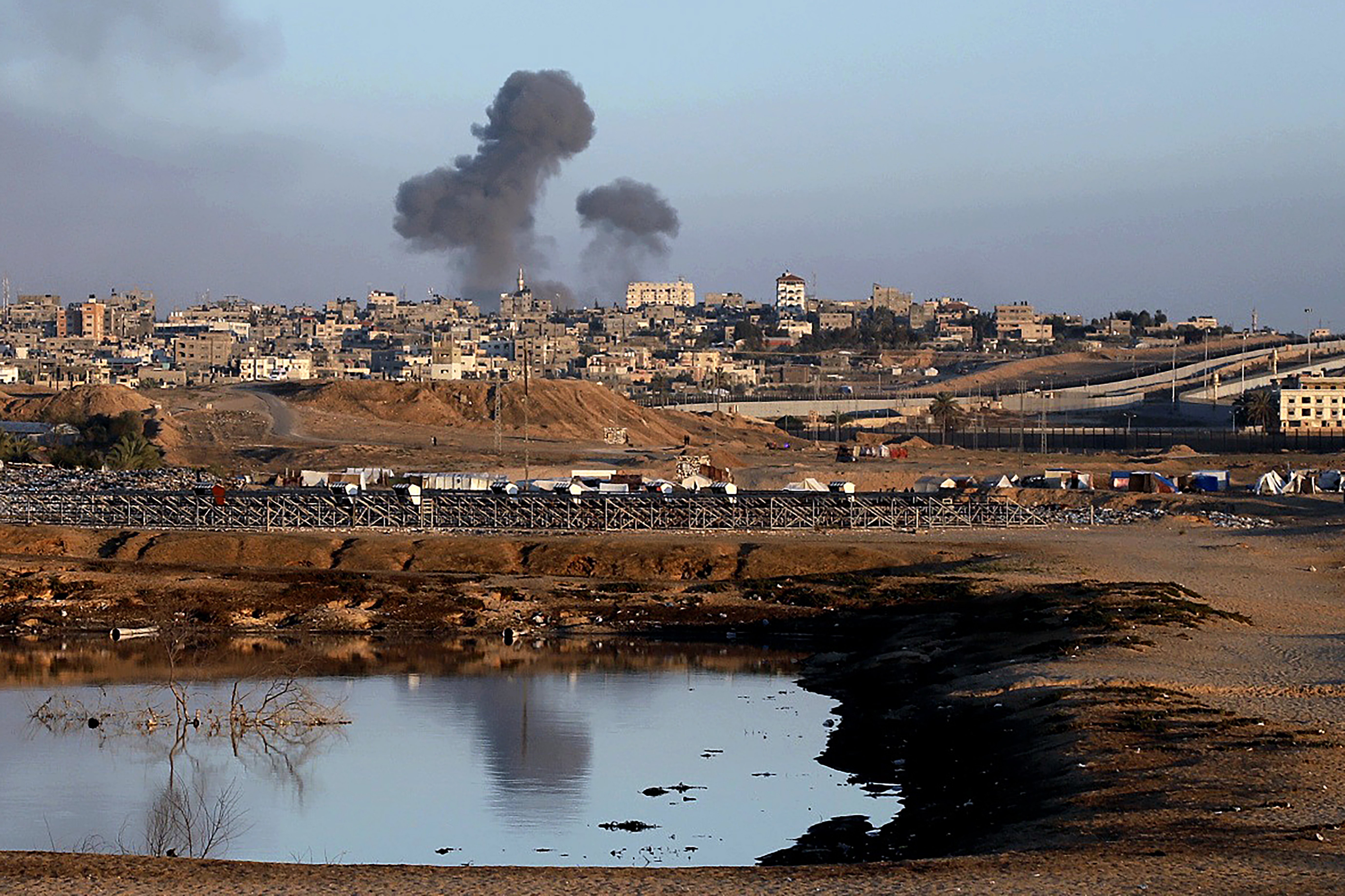 Smoke rises following an Israeli airstrike on buildings near the separating wall between Egypt and Rafah in the southern Gaza Strip. Photo / AP