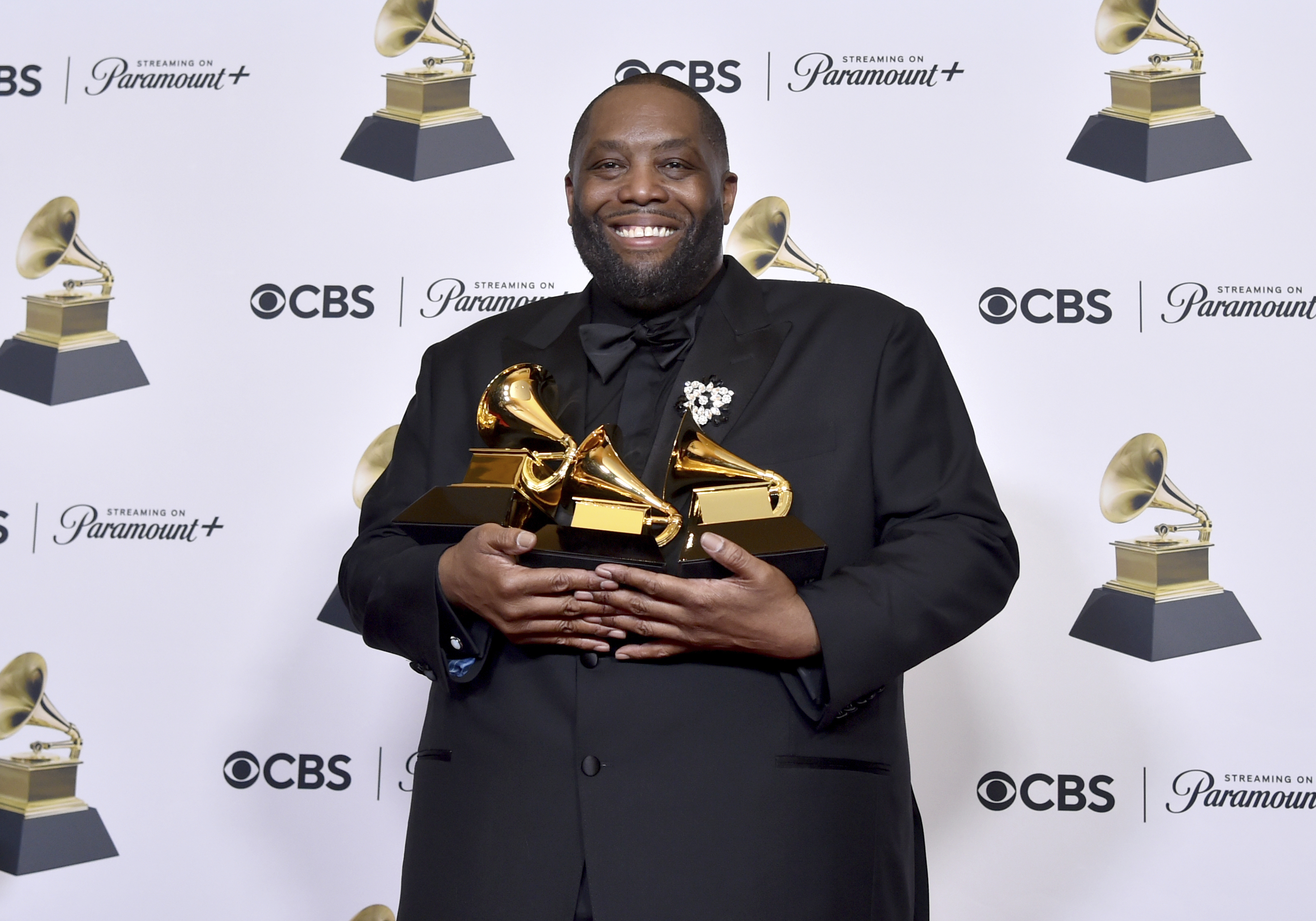Killer Mike poses in the press room with the awards for best rap performance and best rap song. Photo / AP