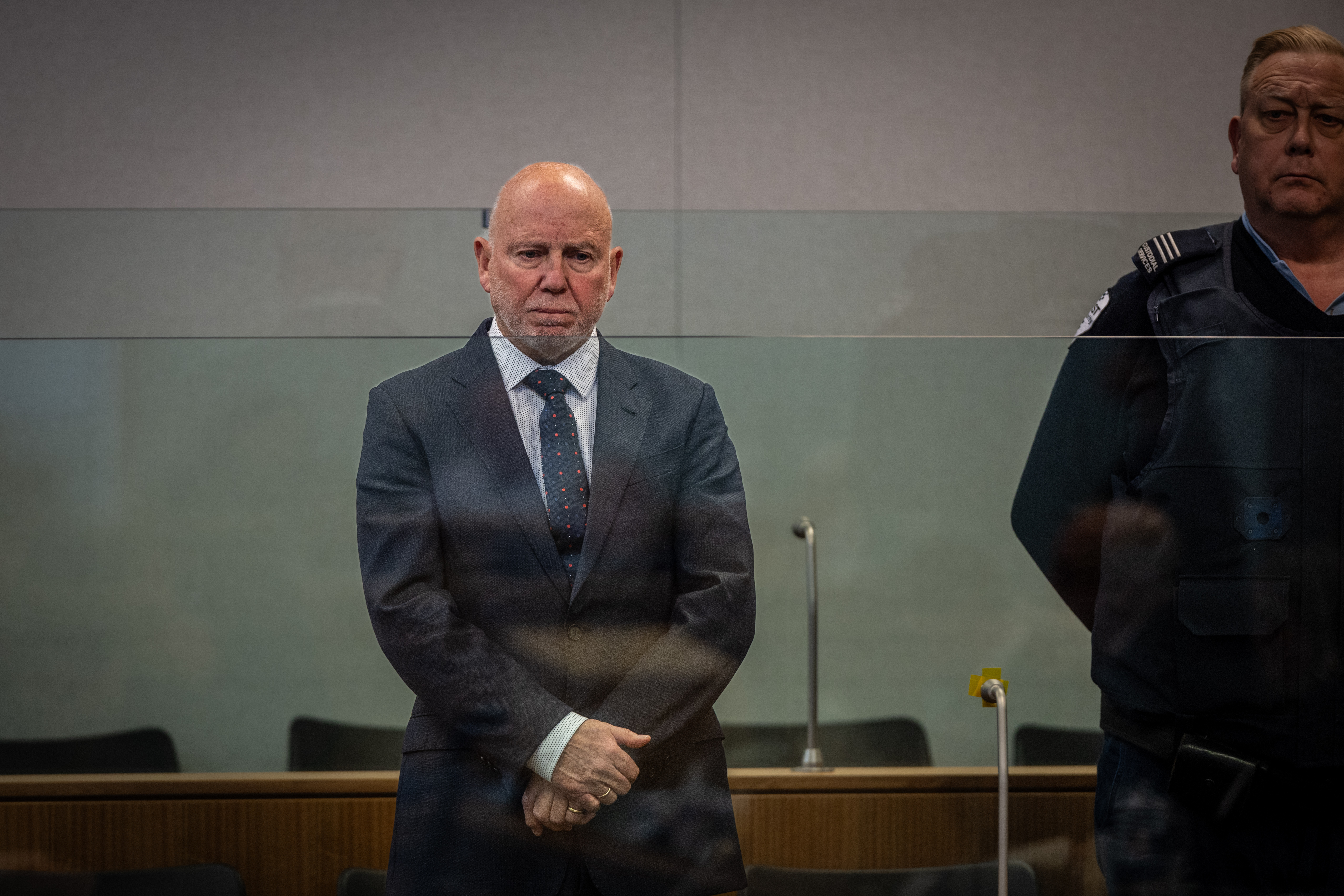 Eye surgeon Philip Polkinghorne, 71, stands in the High Court at Auckland dock as he pleads not guilty to murder at the outset of his trial. He is accused of having strangled wife Pauline Hanna then staging the death to look like a suicide. Photo / Michael Craig