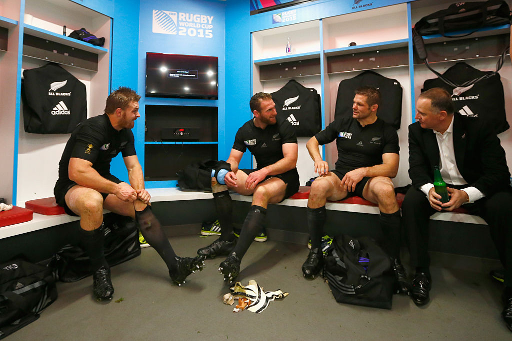 Sam Cane (from left), Kieran Read and Richie McCaw sit with former PM Sir John Key in the dressing room following the 2015 Rugby World Cup semifinal win over South Africa at Twickenham. Photo / Getty Images