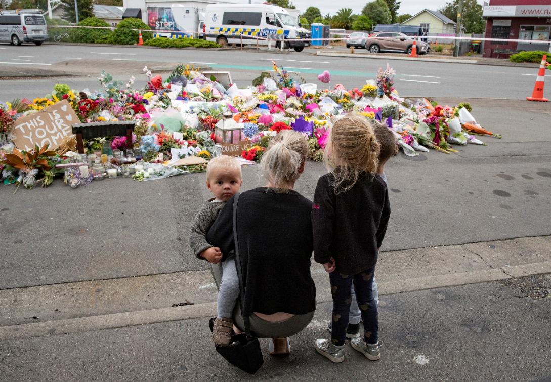 A family laying flowers at the Linwood mosque. Photo / Mark Mitchell