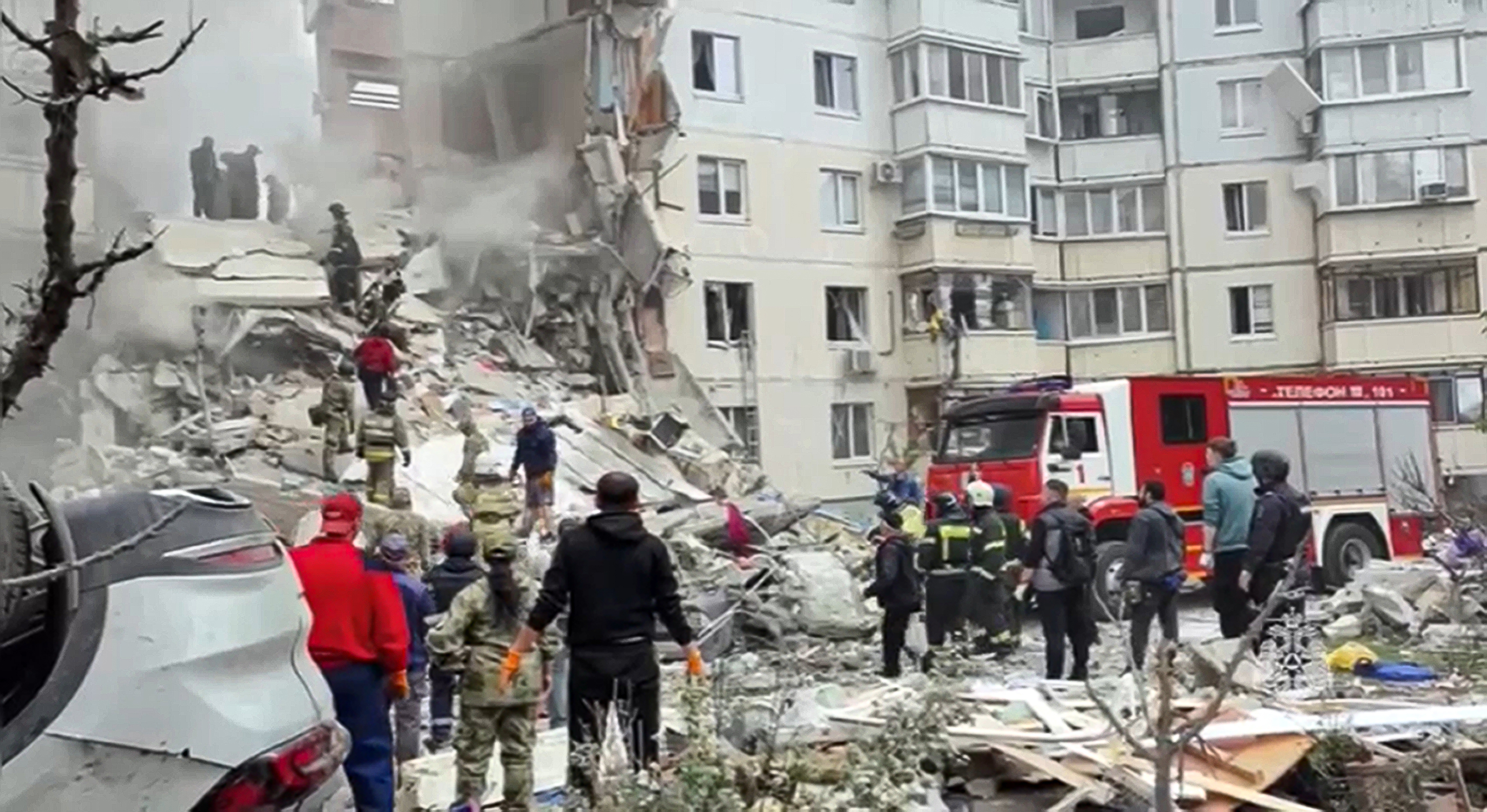 Russian emergency services work at the scene of a partially collapsed block of flats authorities said was hit during an attack by Ukrainian shelling, in Belgorod, Russia. Photo / AP