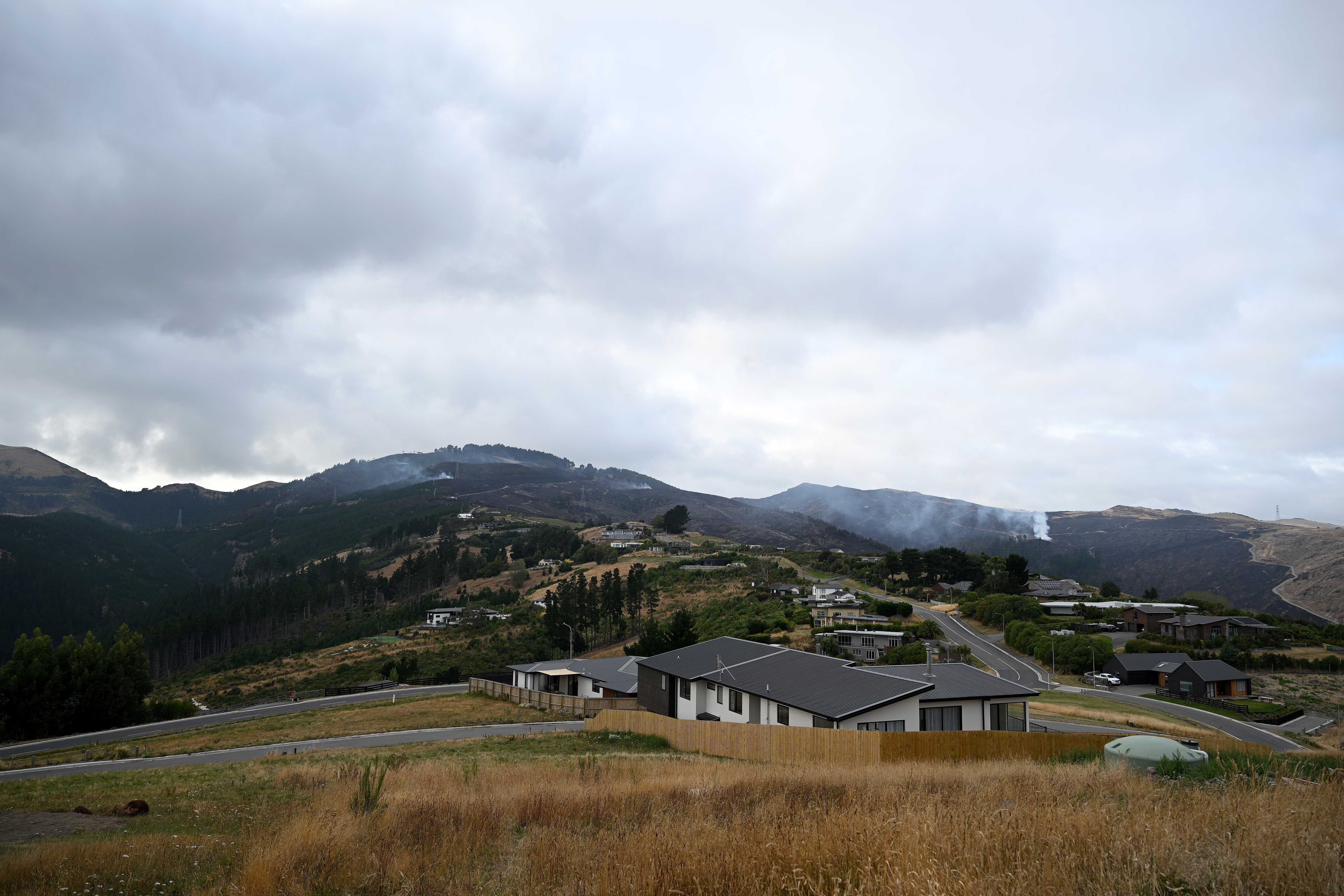 A view of the fire scene as smoke continues to smoulder. A large fire has broken out in Chritchurch’s Port Hills causing mass evacuations. 17 February 2024 New Zealand Herald Photograph by Joe Allison