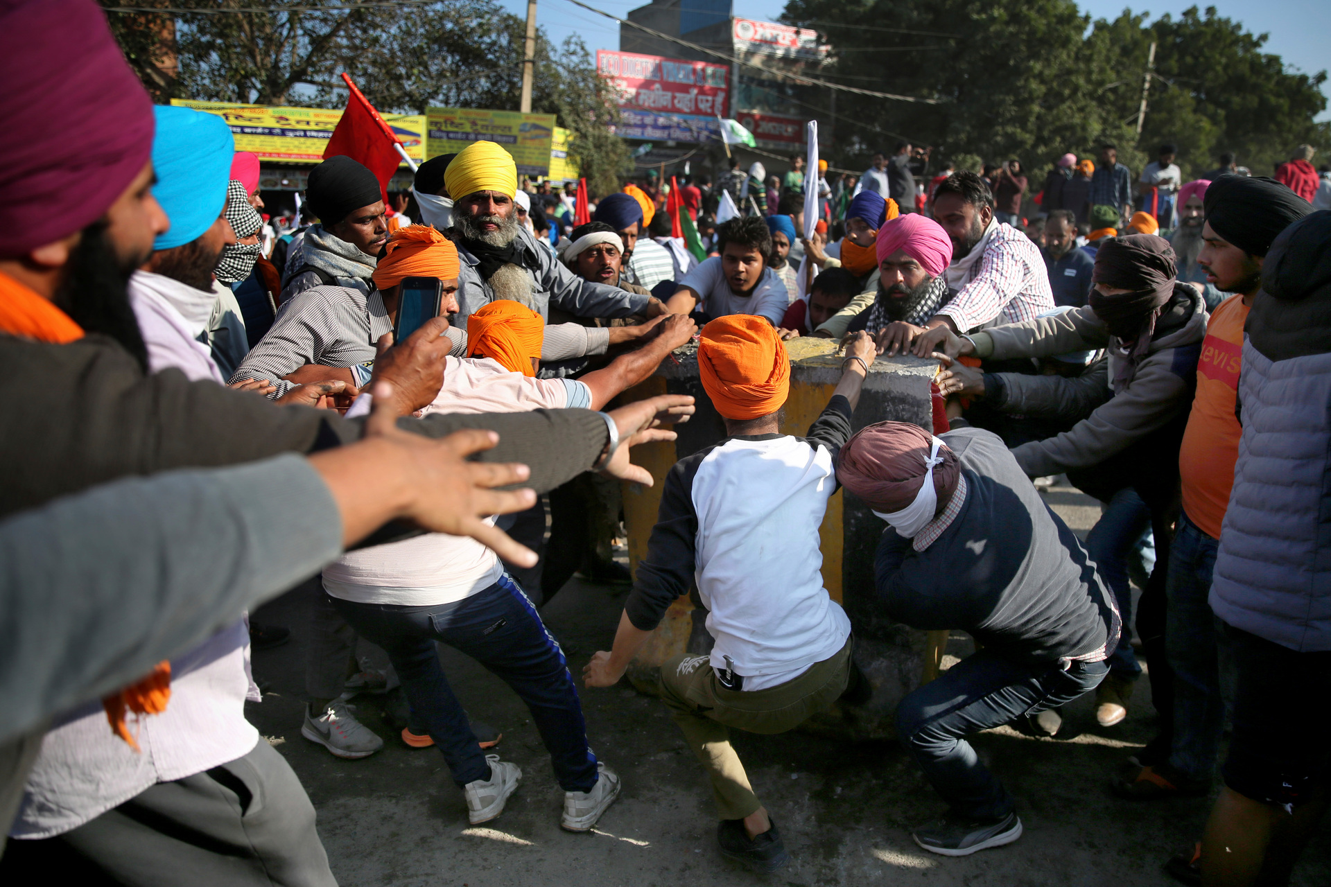 Protesting farmers remove a concrete barricade set up by policemen as they attempt to move towards Delhi. Photo / AP