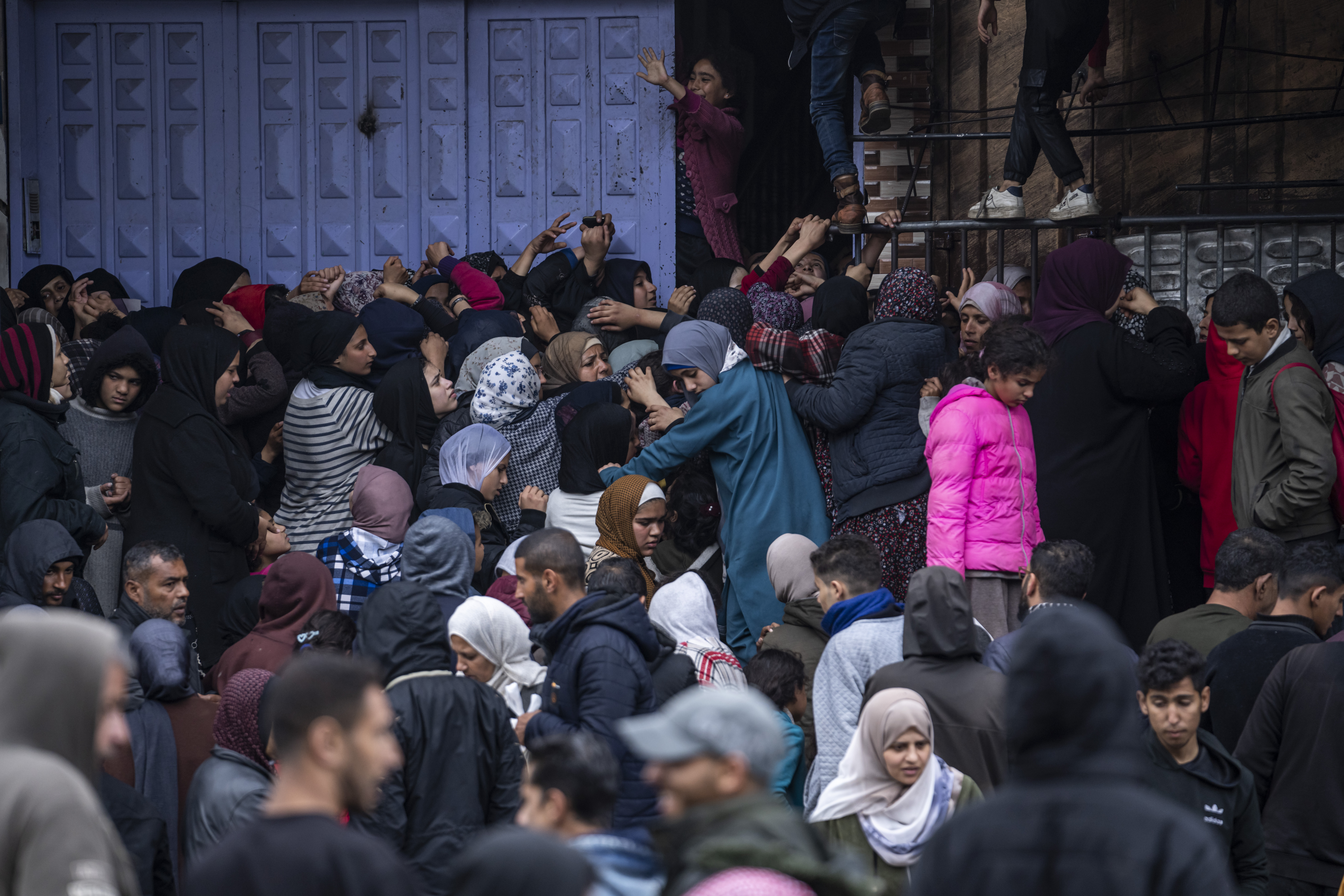 Palestinian crowds struggle to buy bread from a bakery in Rafah, Gaza Strip. Photo / AP