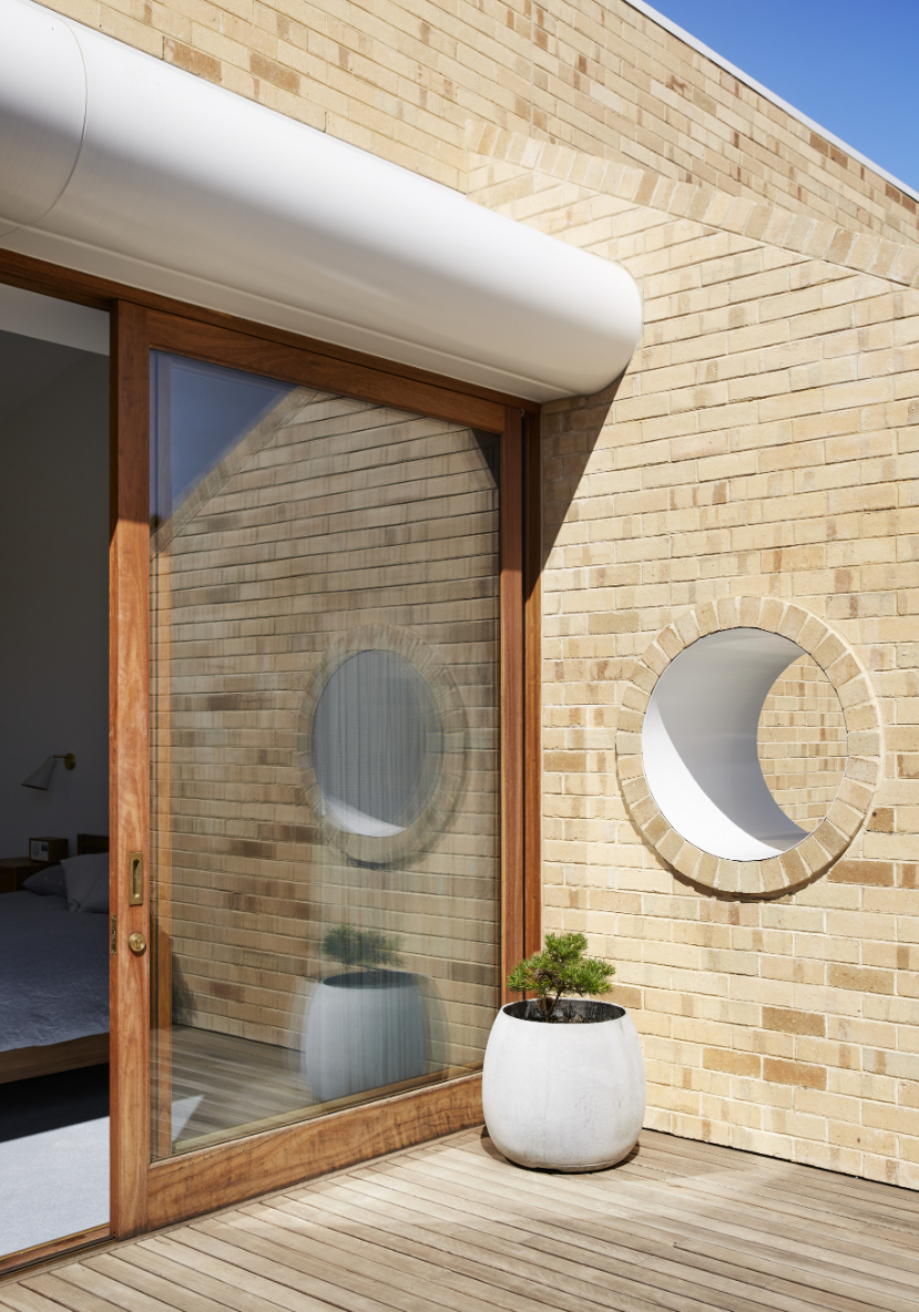 The portholes in the extension’s curved facade are a clever nod to the 1930s. Photo / Tess Kelly