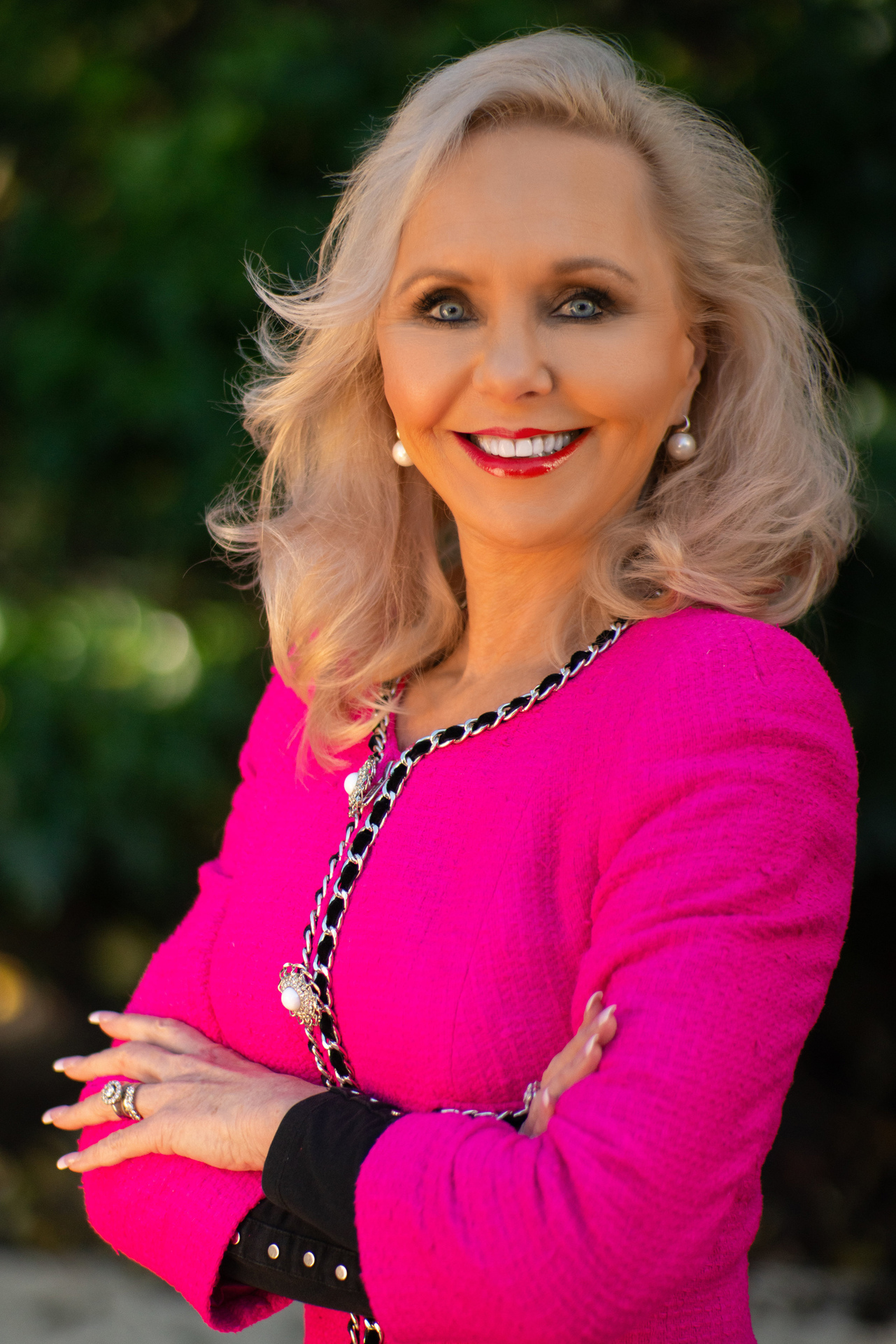 Desley Simpson loves wearing pink and the finer things in life. Photo / Supplied