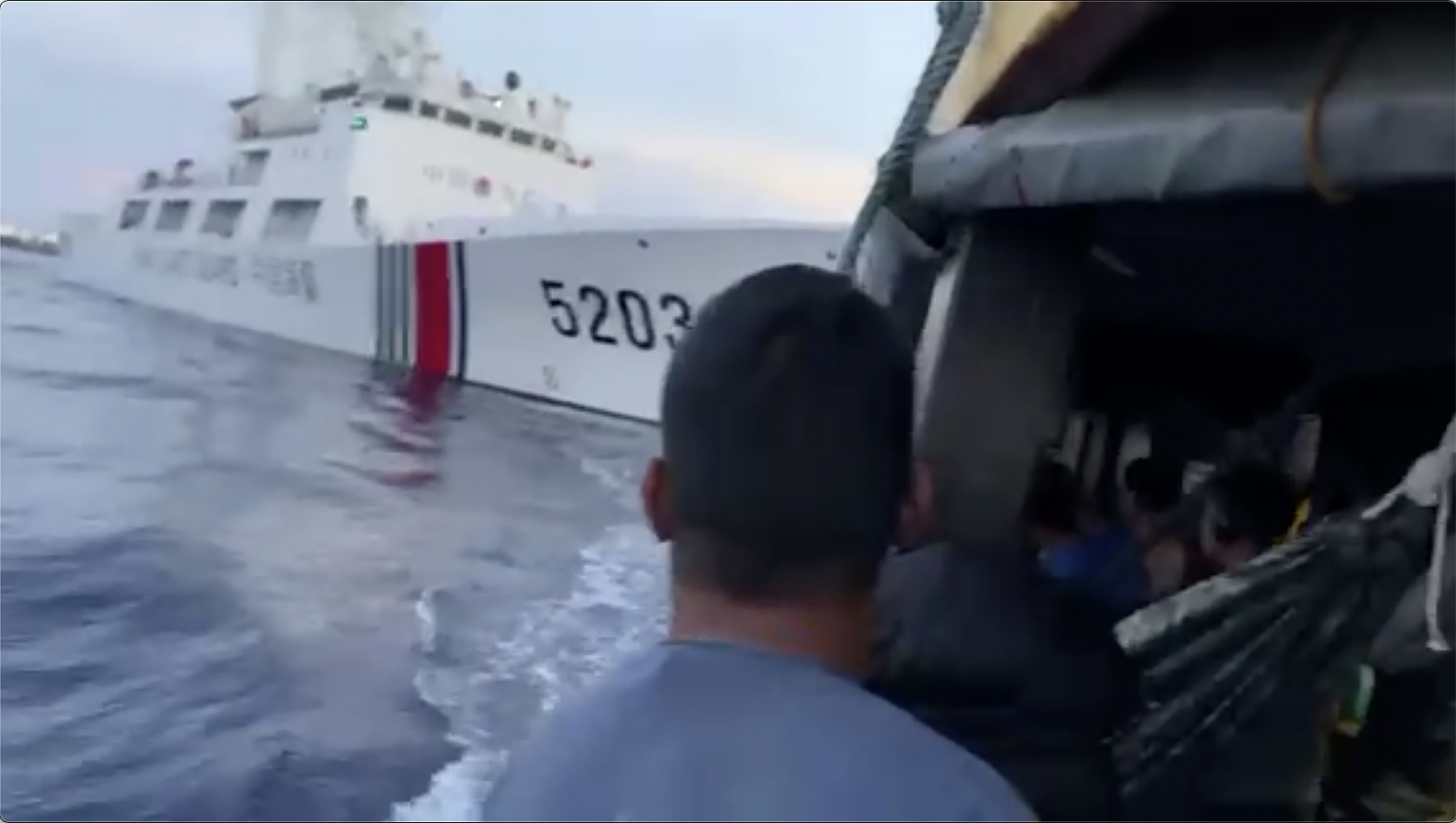 A Chinese coast guard ship with the bow number 5203 bumps a Philippine supply boat as it approaches Second Thomas Shoal. Photo / AP