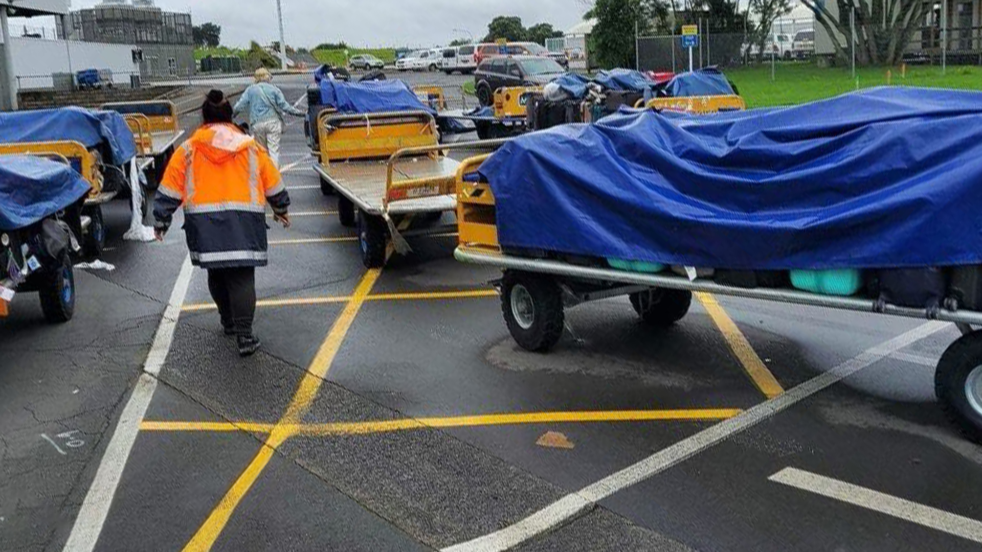 Unclaimed bags were stored outside, under tarpaulins at Auckland International Airport during the floods. Photo / Supplied