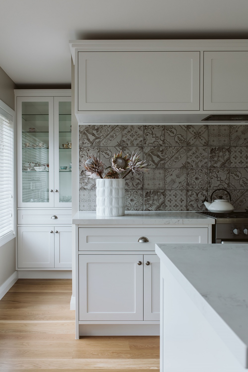 A hidden scullery and the use of a china cabinet as storage helps blend this kitchen by Annika Rowson into the living space. Photo / Gina Fabish @ The Virtue