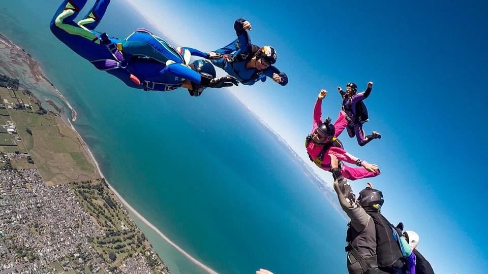 British skydiver Sarah-Jane Bayram (on far left) during free fall over Motueka in March 2020. Photo / Supplied