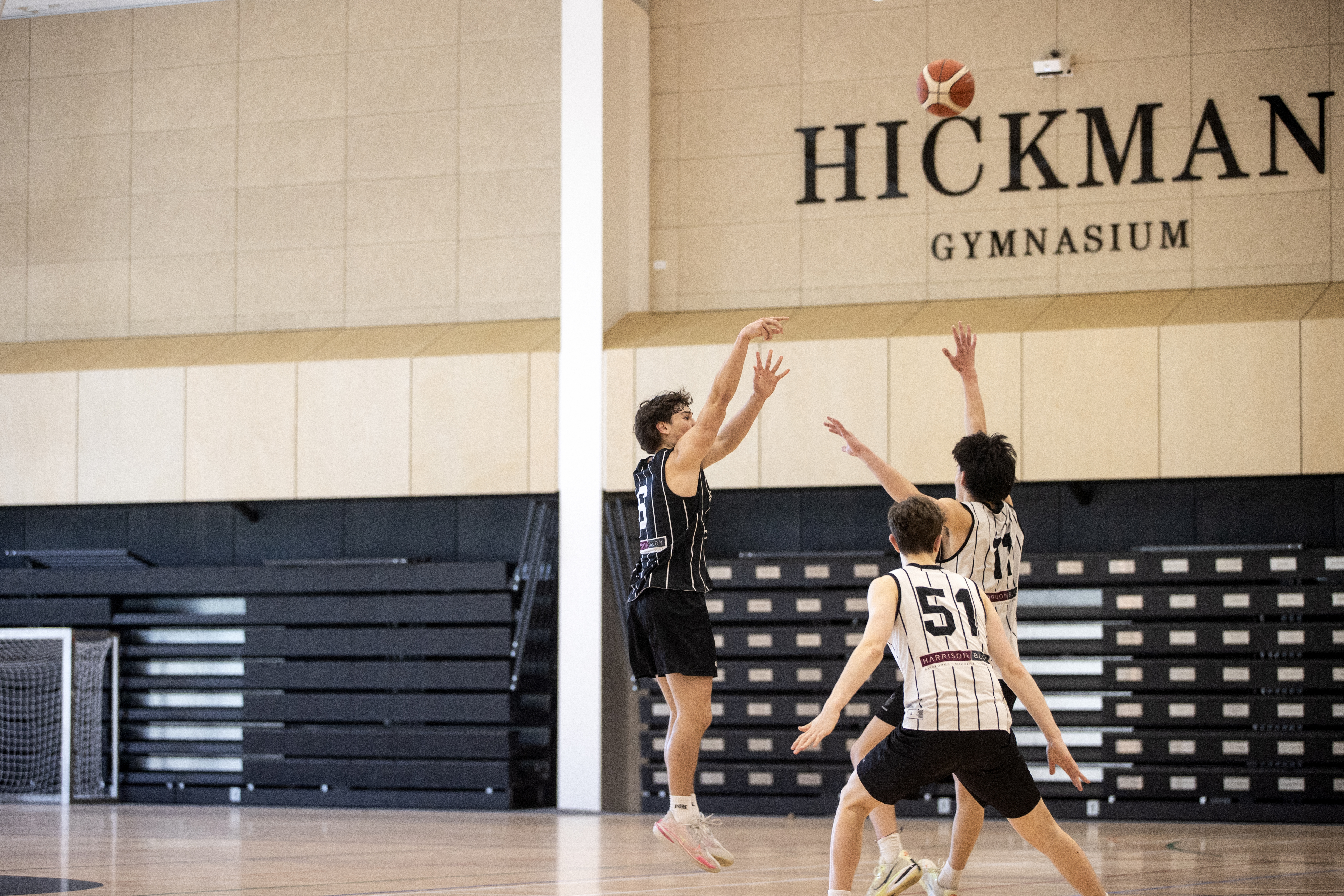Tama Isaac (in black) shoots over Ihaka Cate during practice at Christ's College's new Hickman Gymnasium. Photo / George Heard