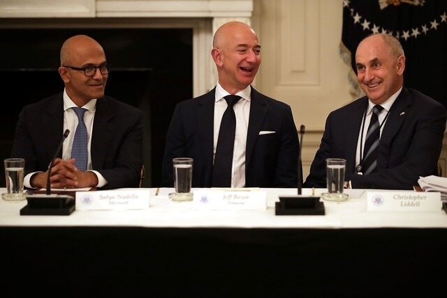 Chris Liddell (right) with Microsoft CEO Satya Nadella (left) and Amazon founder Jeff Bezos at a White House tech conference.