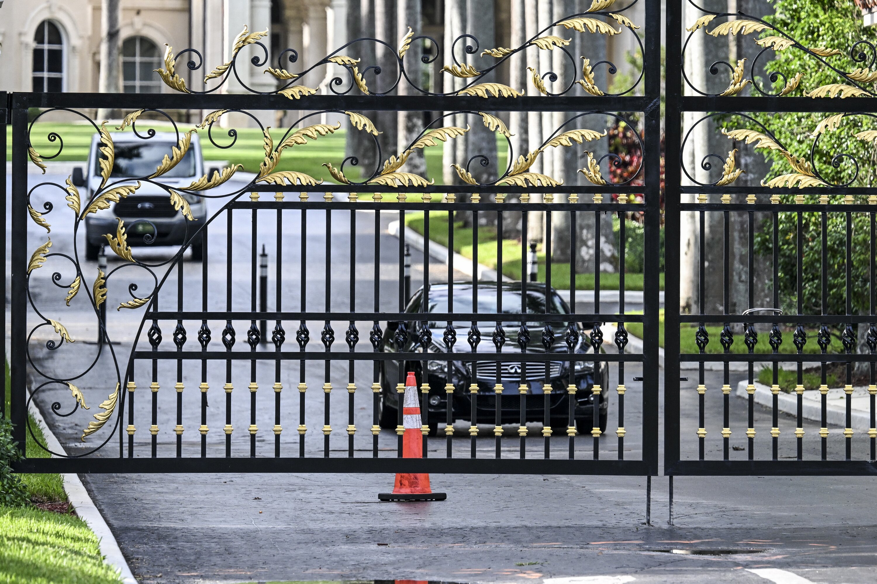 A police car blocks the main gate of the Trump International Golf Club in West Palm Beach, Florida following a shooting incident at former US president Donald Trump's golf course. Photo / AFP