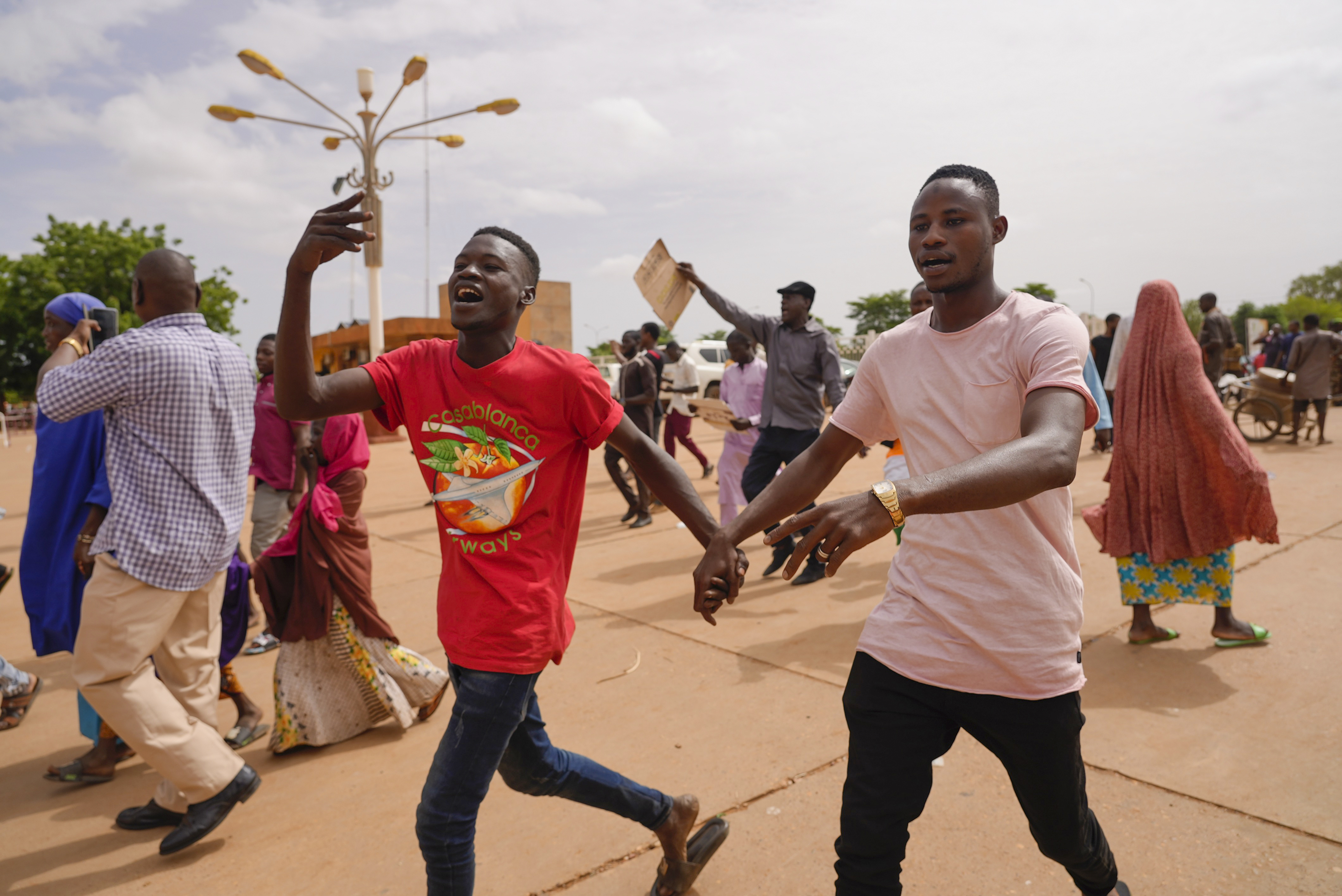 Supporters of Niger's ruling junta cheer in Niamey on Sunday. Nigeriens are bracing for a possible military intervention as time runs out for its new junta leaders to reinstate the country's ousted president. Photo / AP